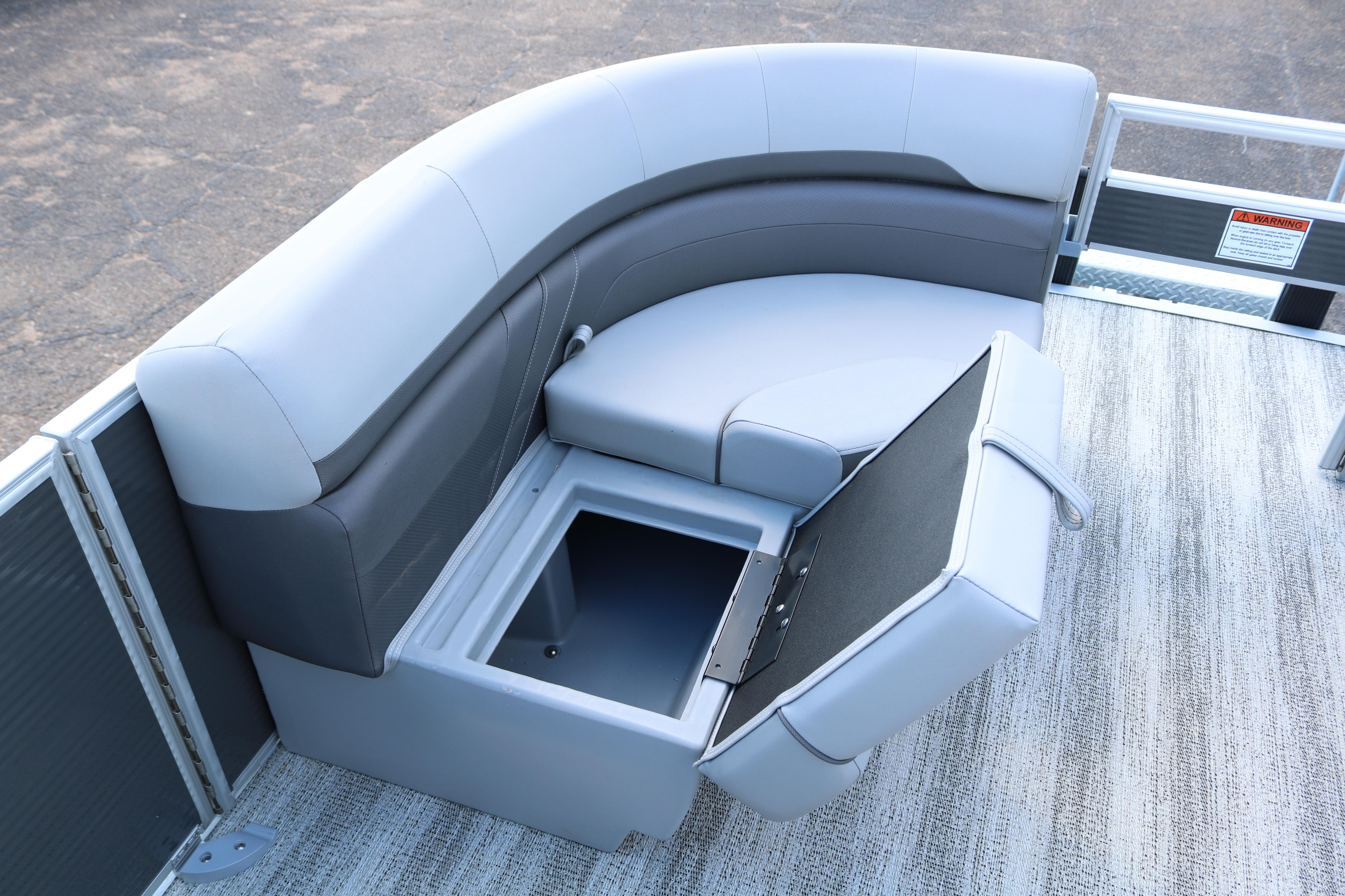 2026 Bennington 20SXSNP REAR FISH boat with open storage compartment and cushioned seating.