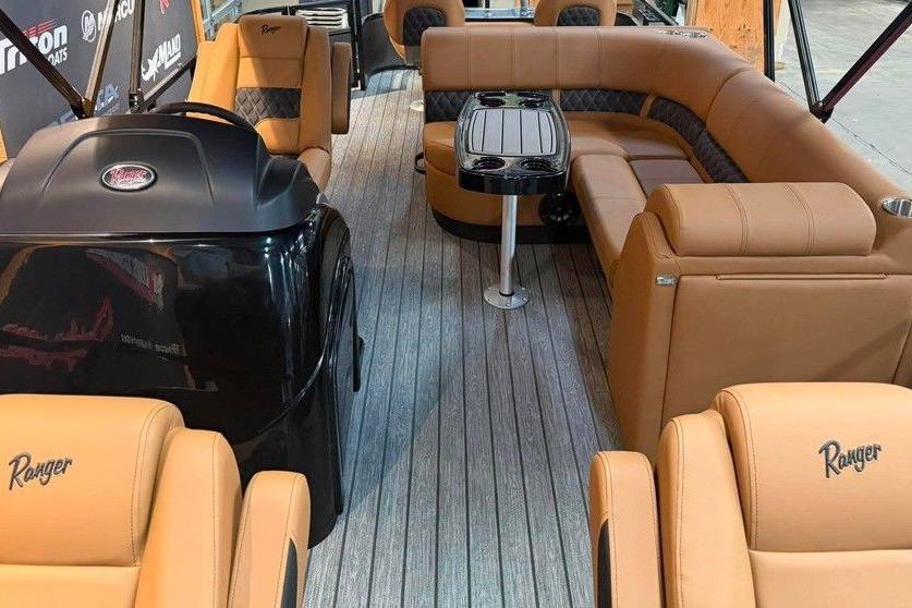 Luxurious interior of 2026 Ranger 220F boat with tan seating and sleek design.