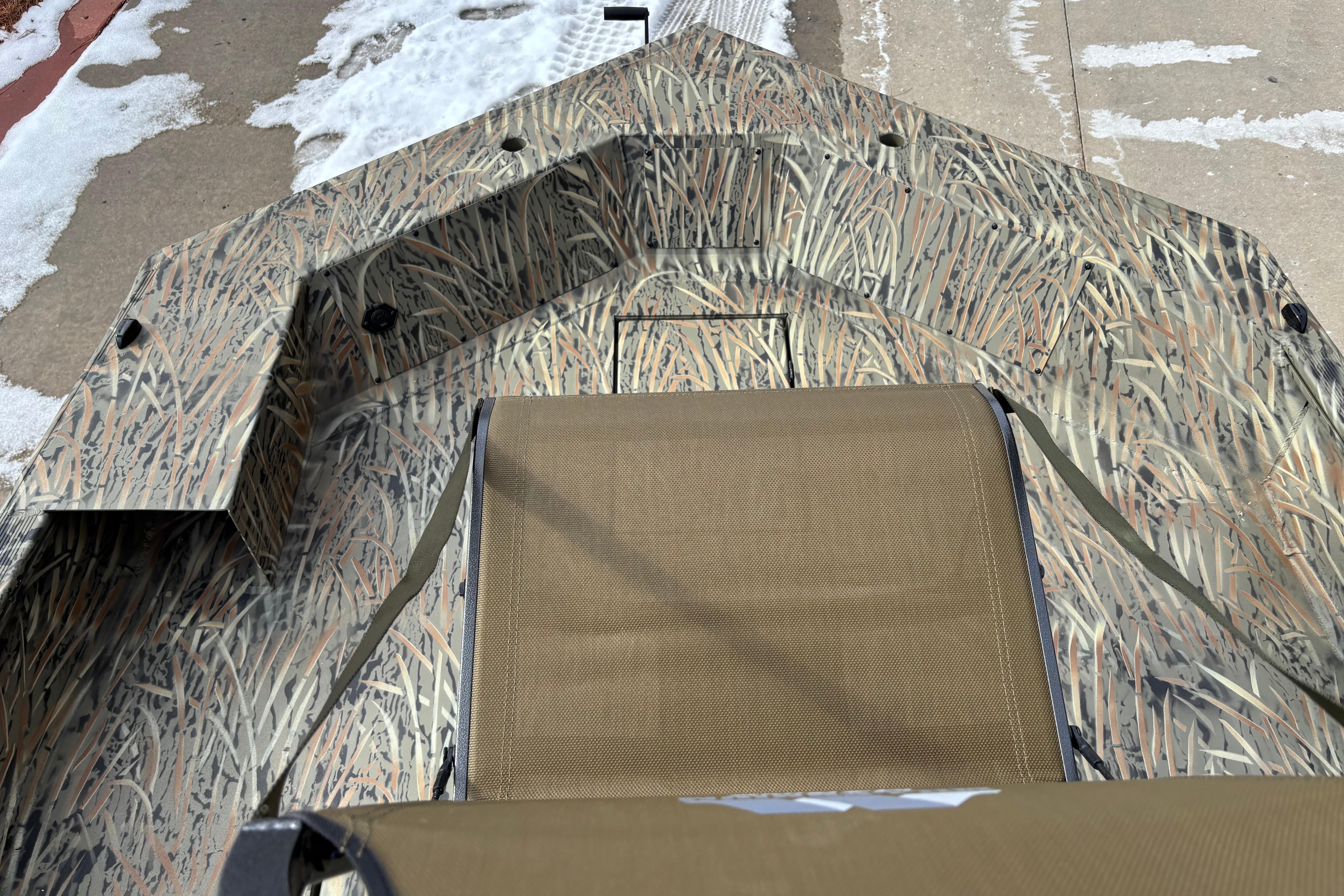 2026 Tracker Grizzly 1756 T Marsh boat with camouflage design and seating.