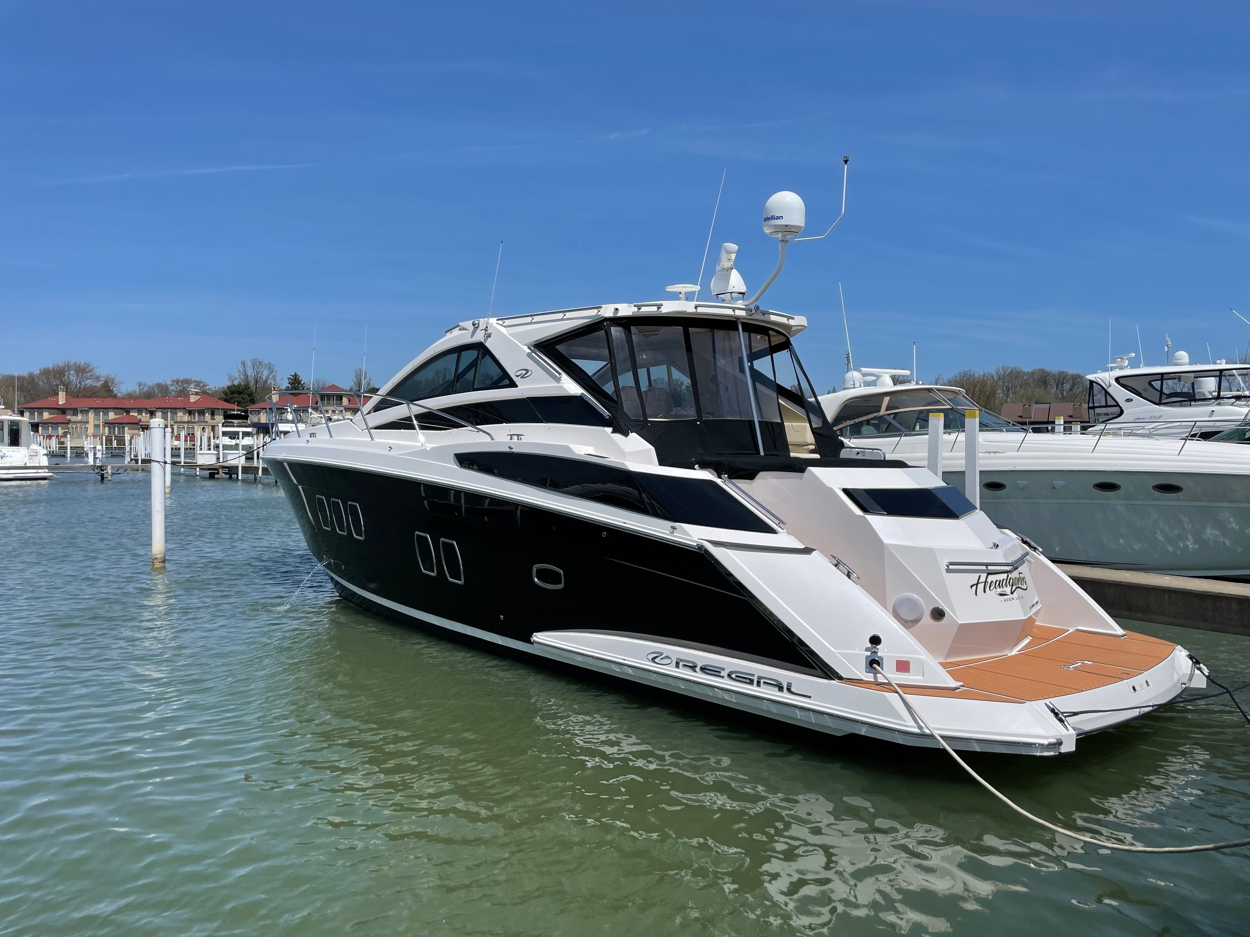 2010 Regal 52 Sport Coupe yacht docked in harbor.