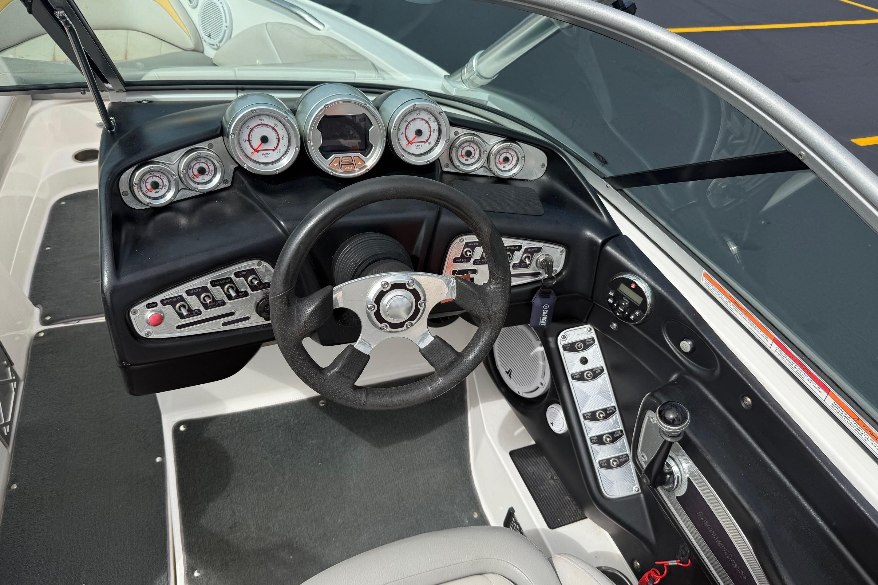 2008 MasterCraft X-15 boat dashboard with steering wheel and control panel.