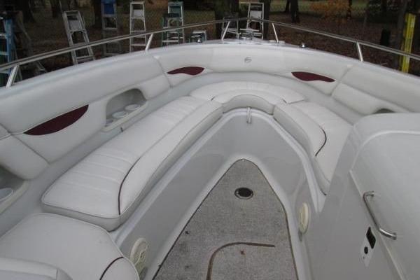 2004 Crownline 288 BR boat interior with white seating and spacious layout.