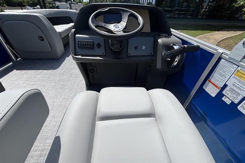 Interior view of 2026 Sun Tracker Party Barge 18 DLX, featuring steering console and seating.