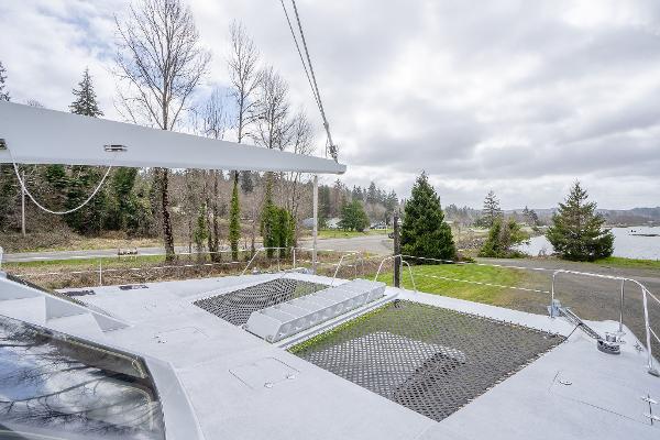 2025 Shuttleworth 52 AeroRig yacht deck with scenic forest and lake view.
