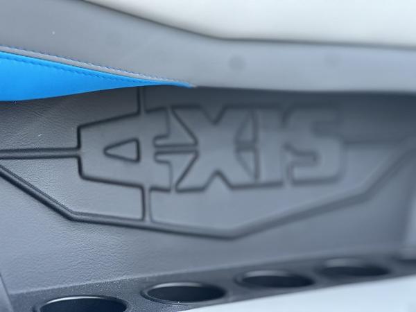 2025 Axis A225 boat interior detail with logo and cup holders.