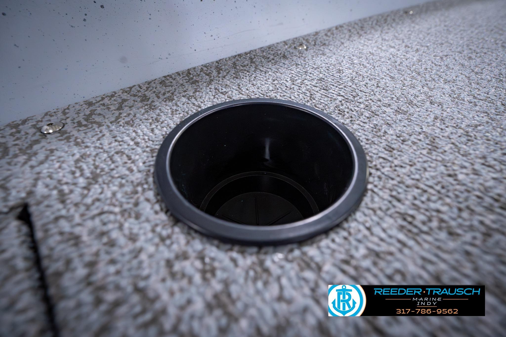 Cup holder on 2026 Lund 1600 Fury SS boat deck, textured surface, Reeder-Trausch Marine logo.