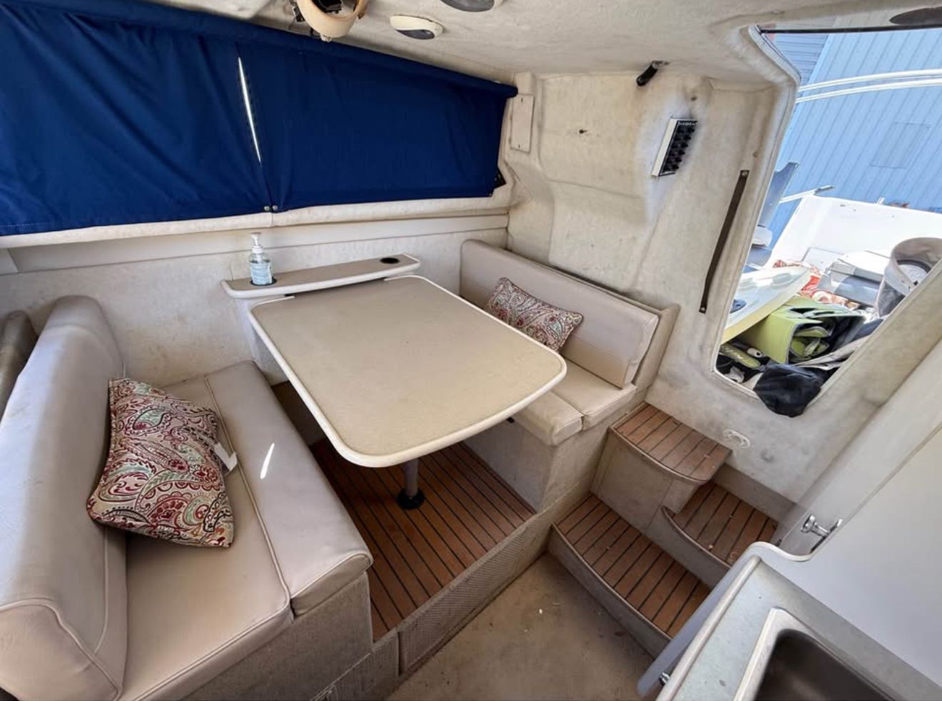 Interior of a 2003 Bayliner 2452 Classic Cruiser with table and seating area.