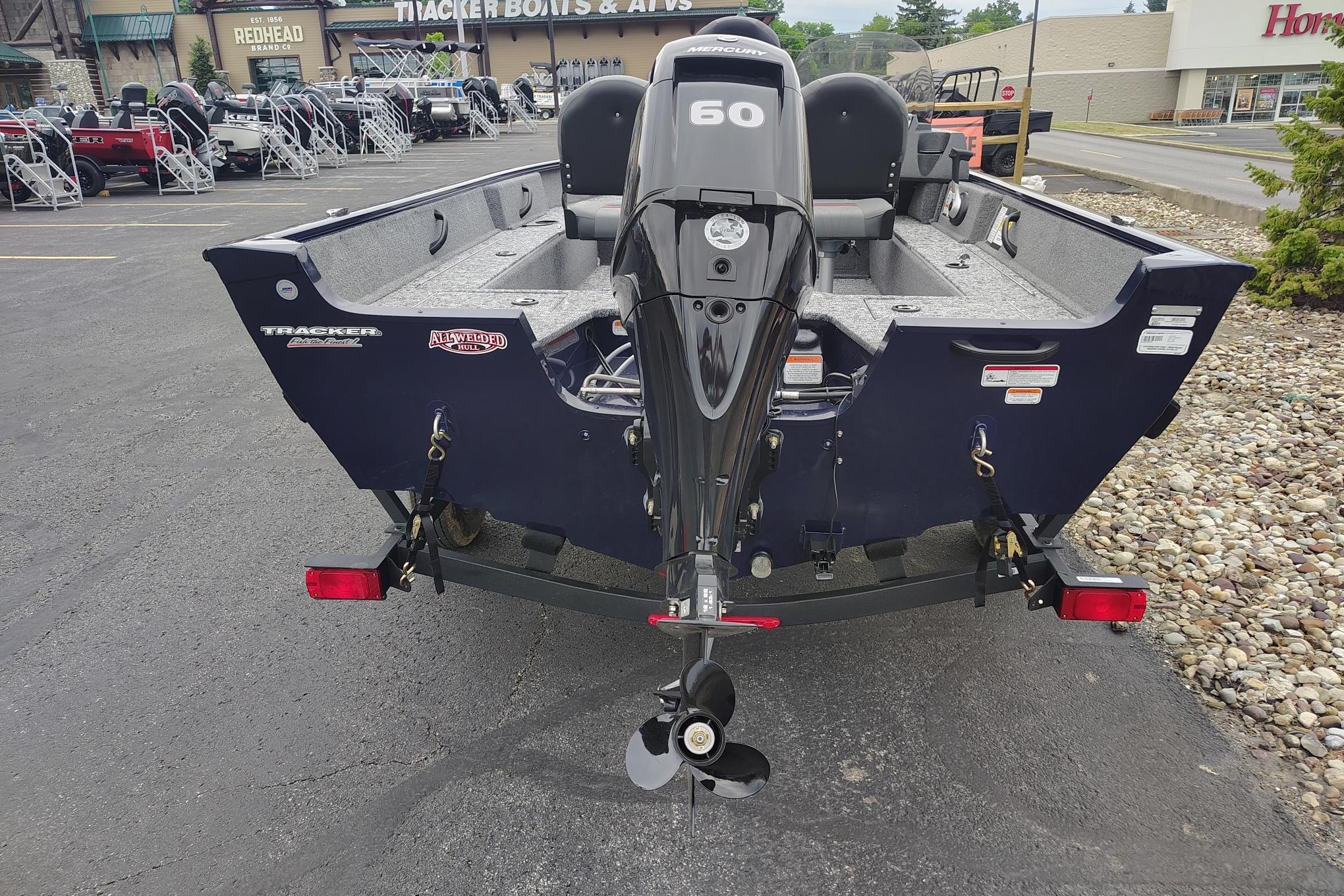 2026 Tracker Pro Guide V-16 SC boat with Mercury 60 engine, parked outdoors.
