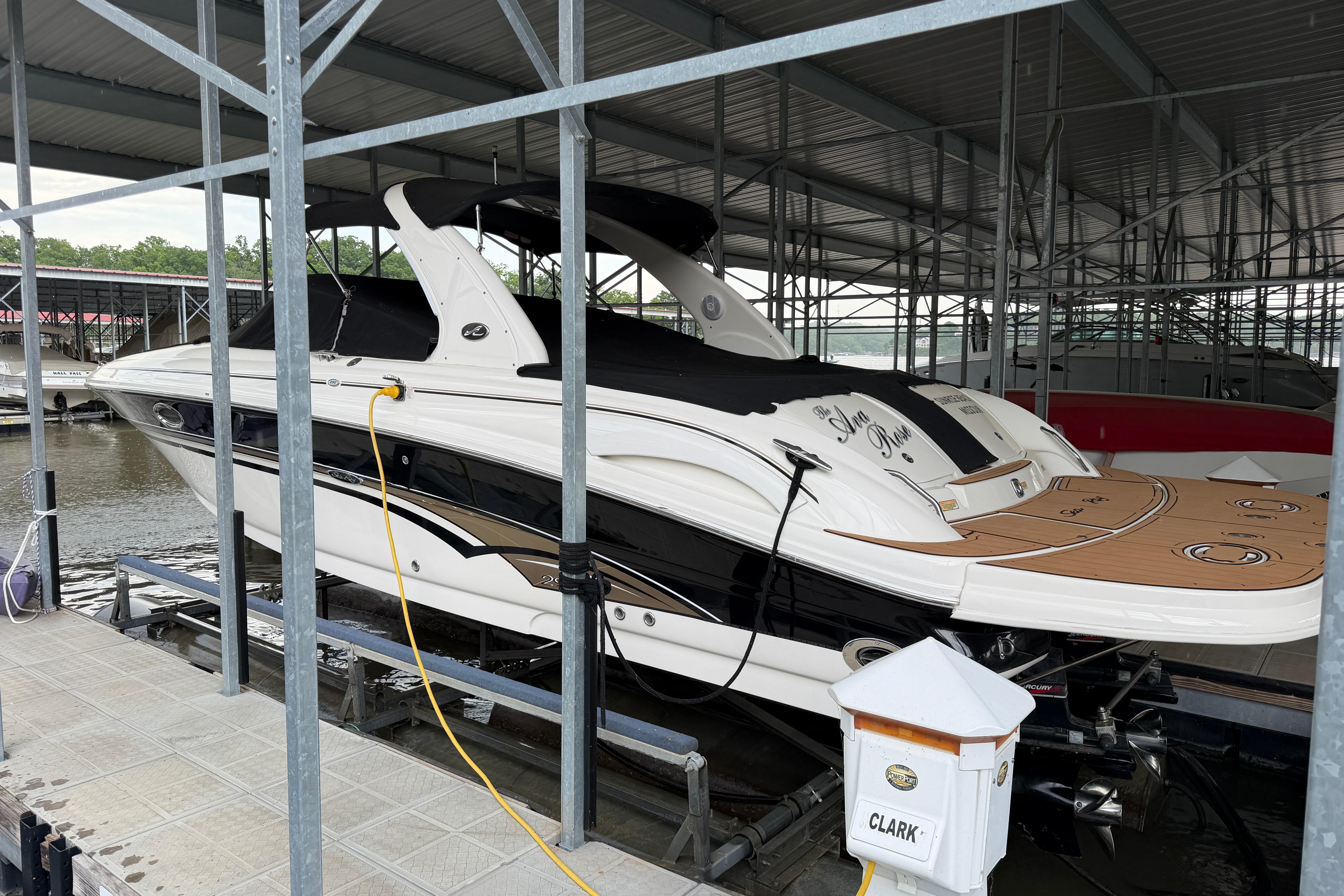 2003 Sea Ray 290 Bowrider docked in a covered marina slip.