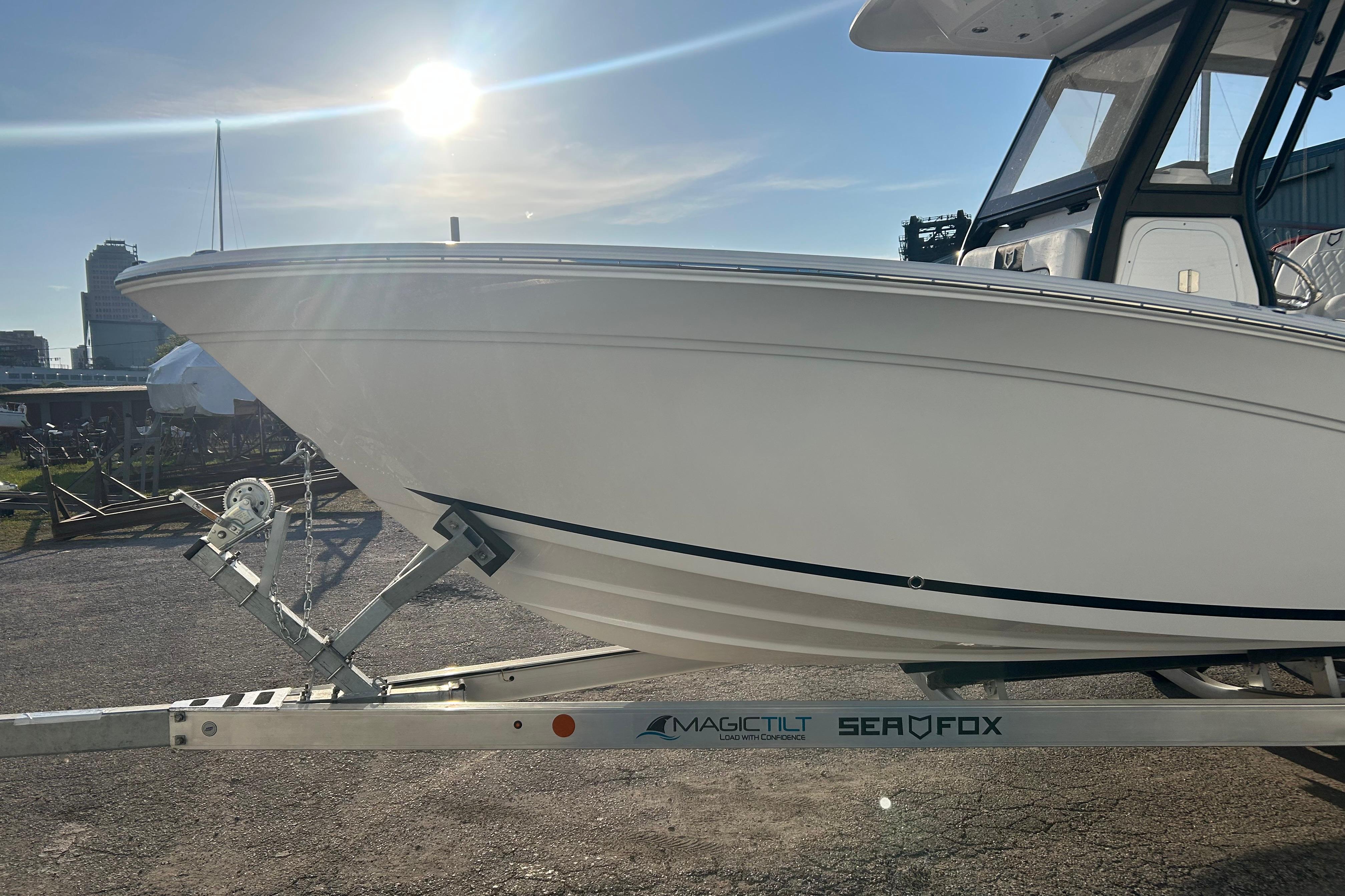 2026 Sea Fox 248 Commander boat on trailer under bright sun.