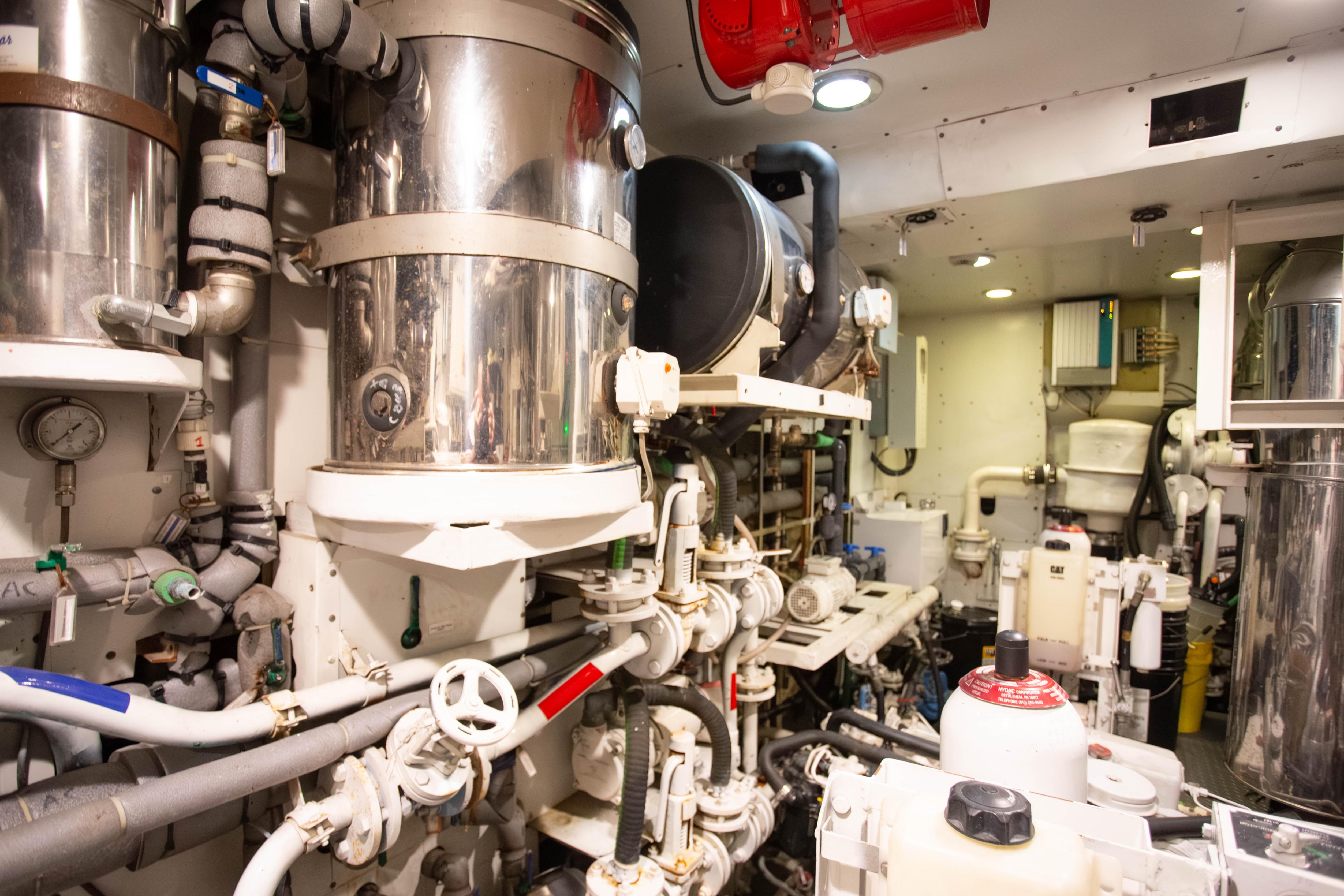 Engine room of 2014 Fifth Ocean Yachts 24m Displacement Explorer Yacht, showcasing complex machinery.