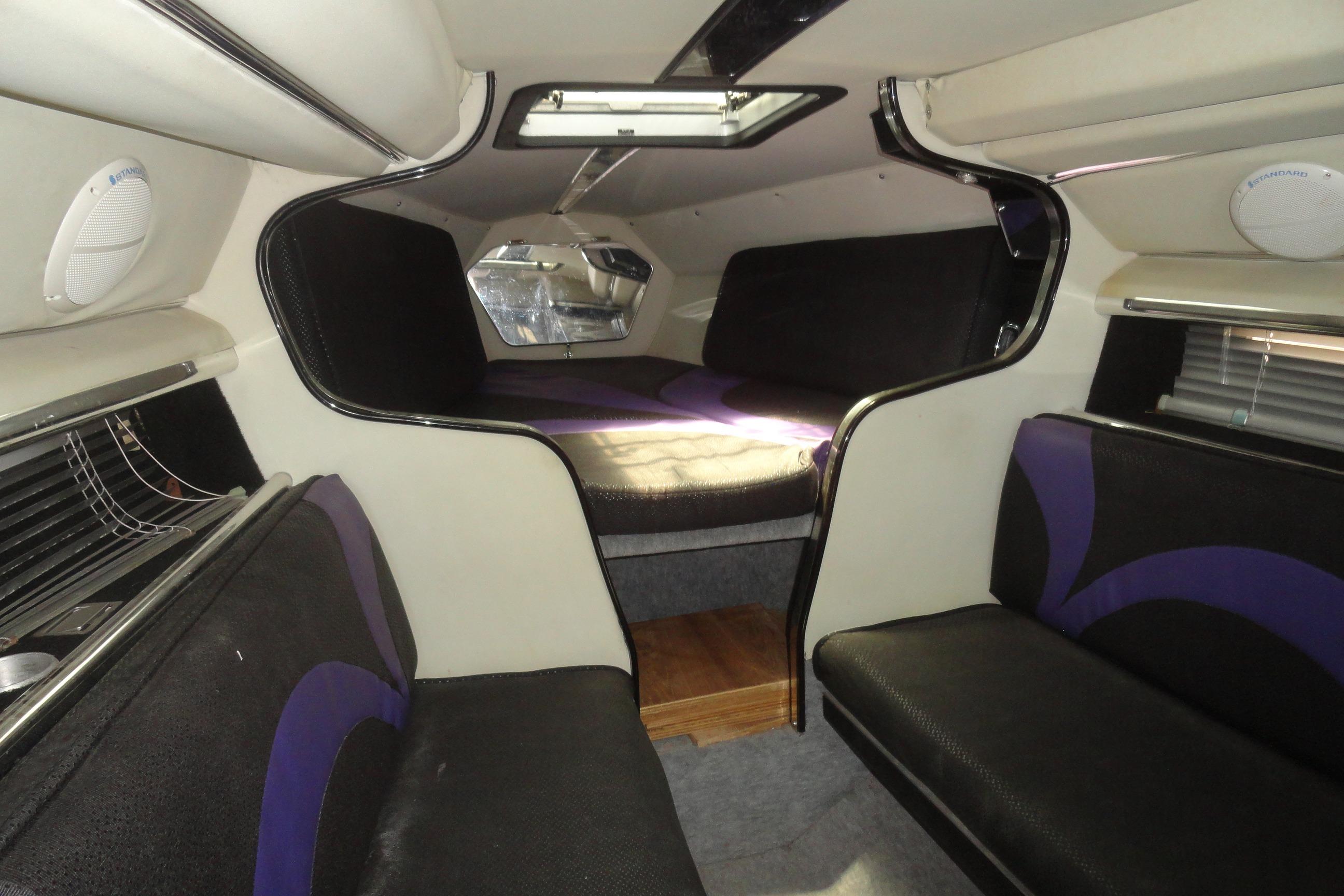 Interior of 1988 Wellcraft 34 Scarab boat with seating and sleeping area.