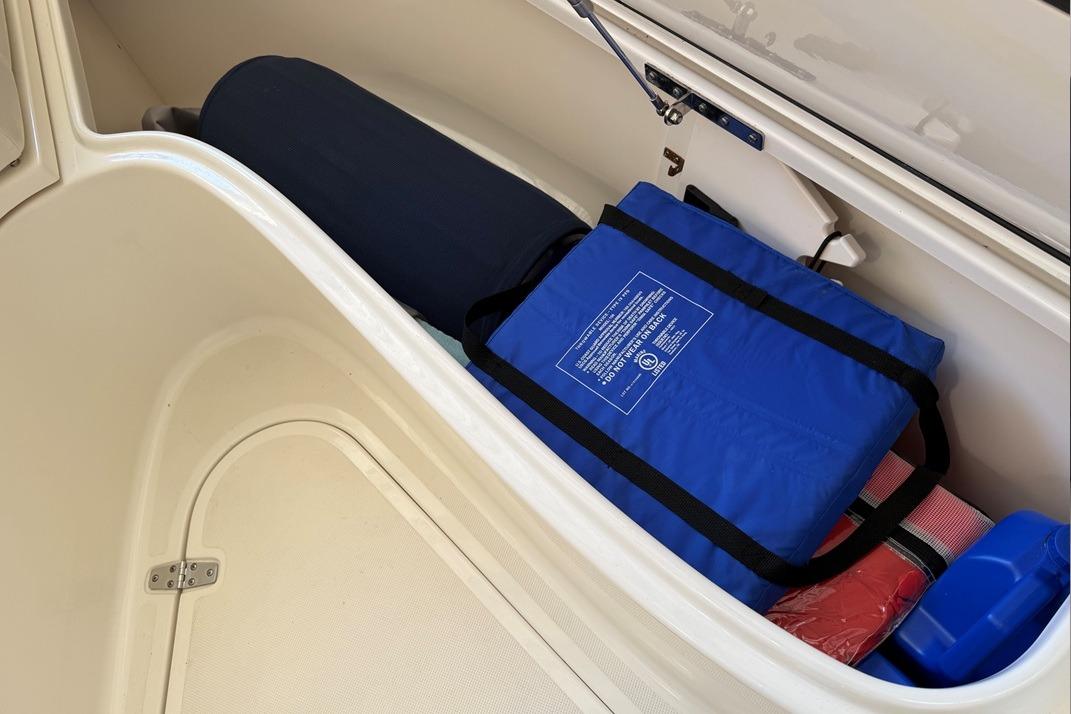 Storage compartment of 2007 Pursuit C 310 Center Console with safety gear.