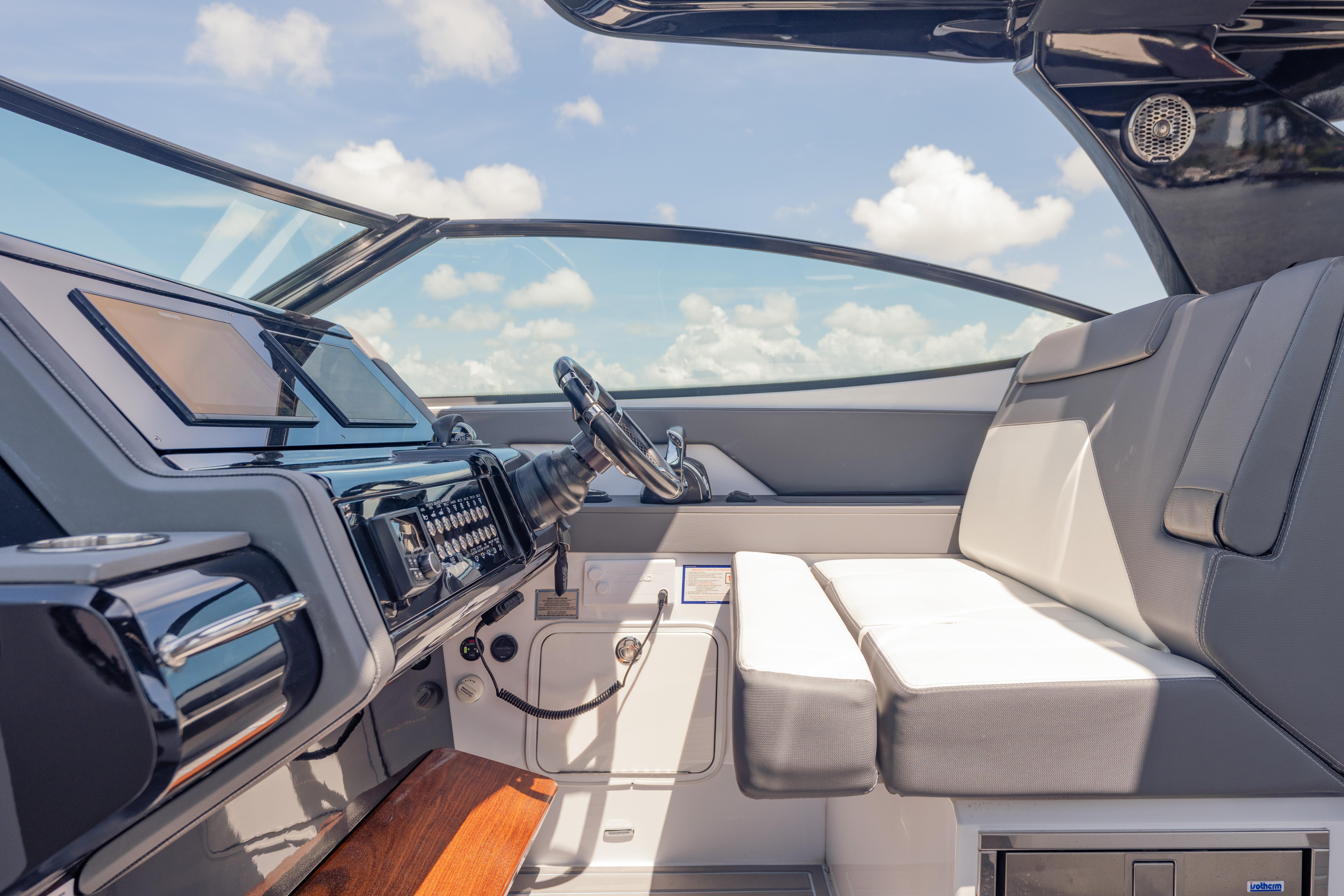 Interior of 2021 Cruisers Yachts 38 GLS, featuring sleek dashboard and comfortable seating.