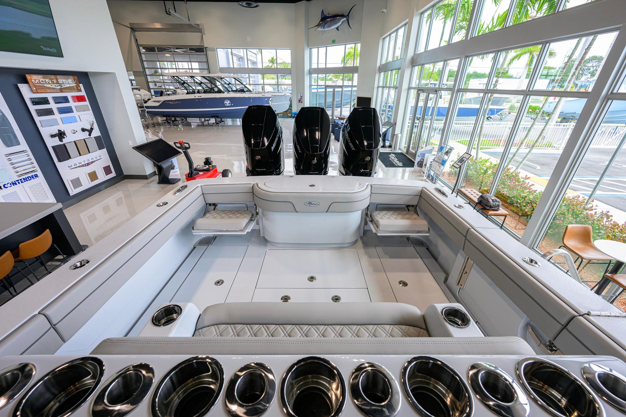 2026 Valhalla Boatworks V-37 interior with triple outboard engines in a showroom setting.