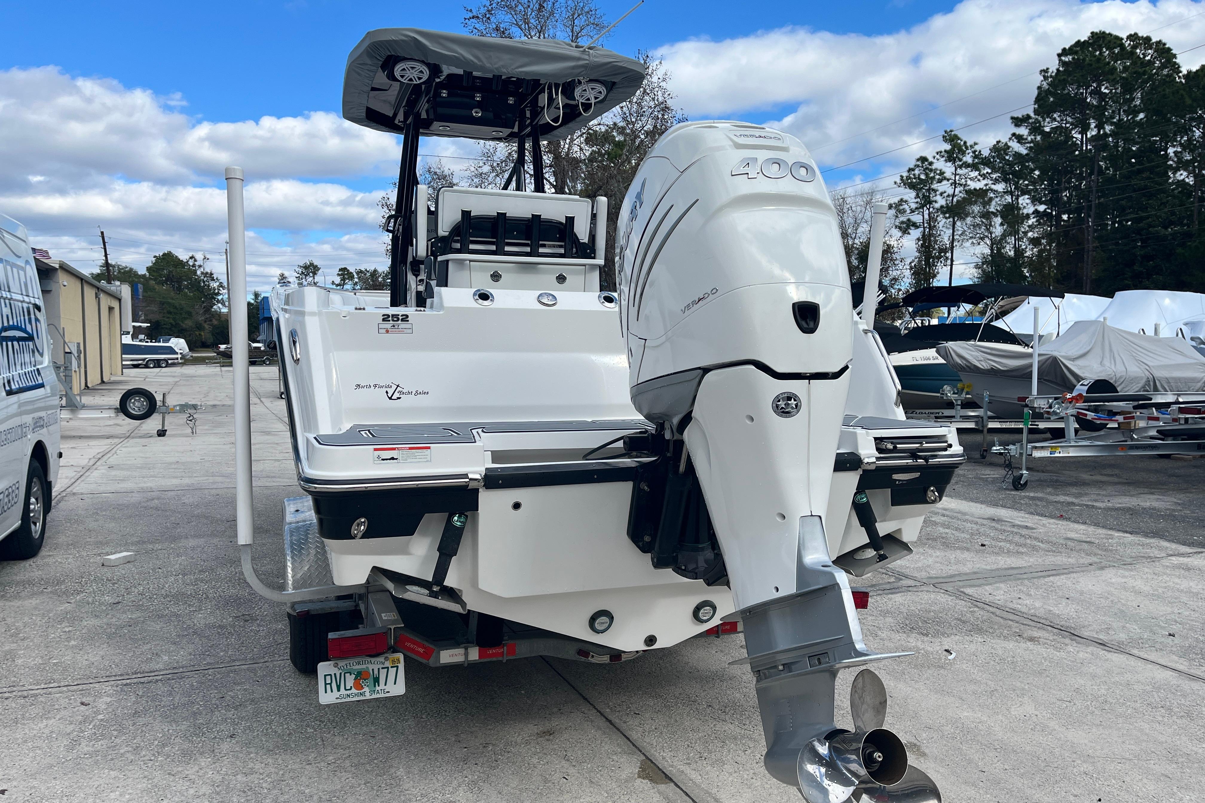 2021 Blackfin 252 CC boat with powerful outboard motor, parked outdoors.
