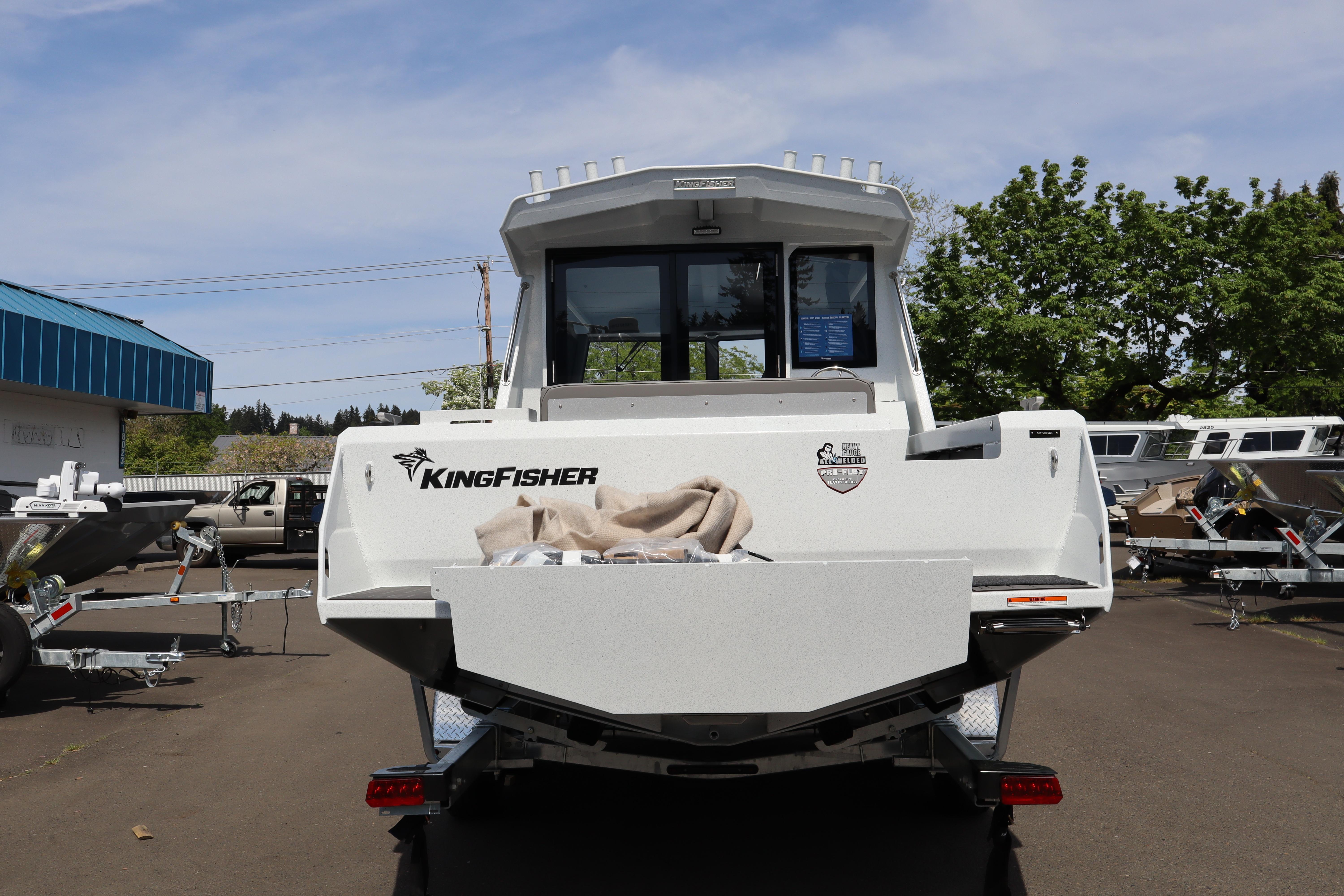 2026 KingFisher 25 XAC boat rear view in outdoor showroom.