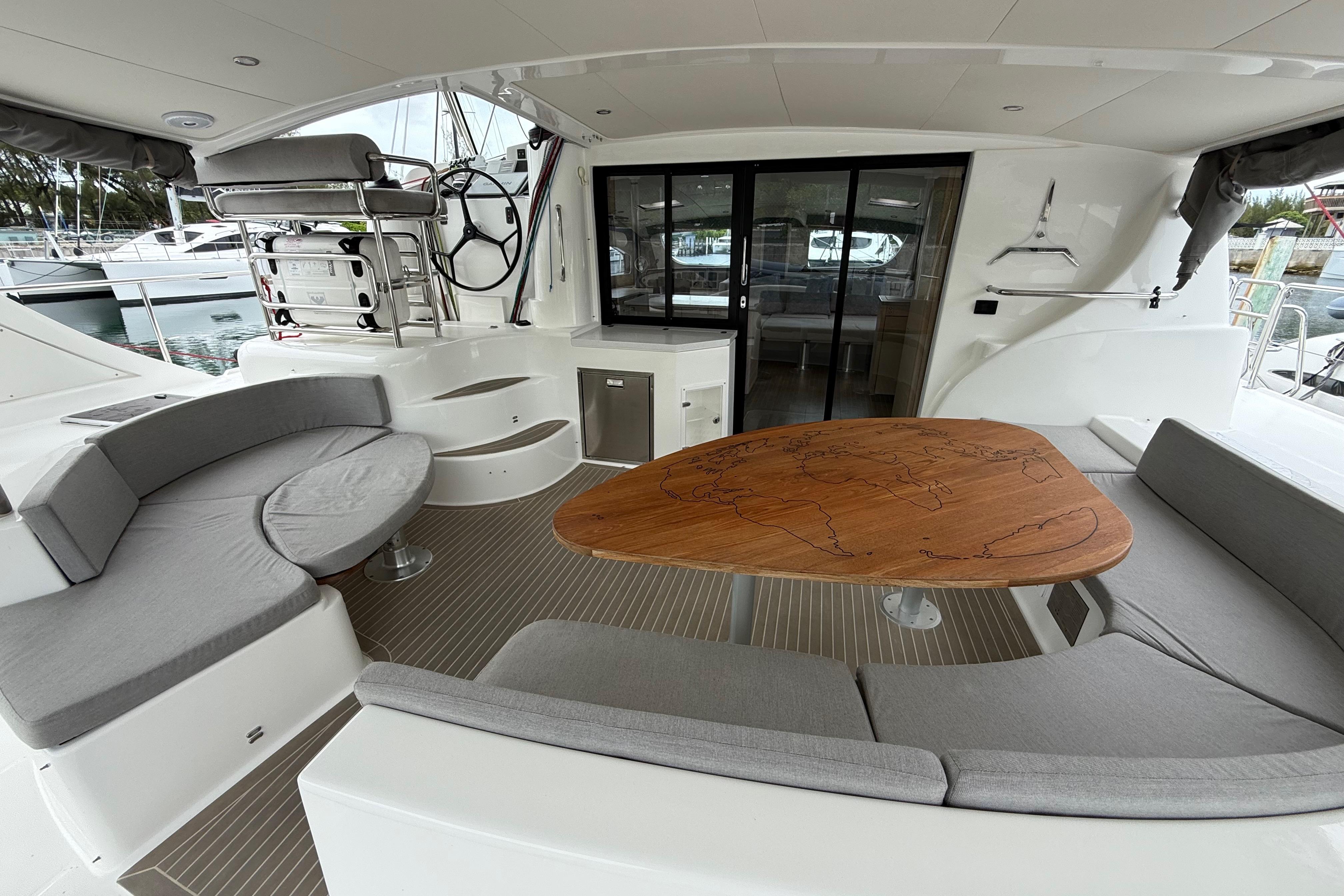 Luxurious 2021 Xquisite Yachts X5 PLUS interior with elegant seating and wooden table.