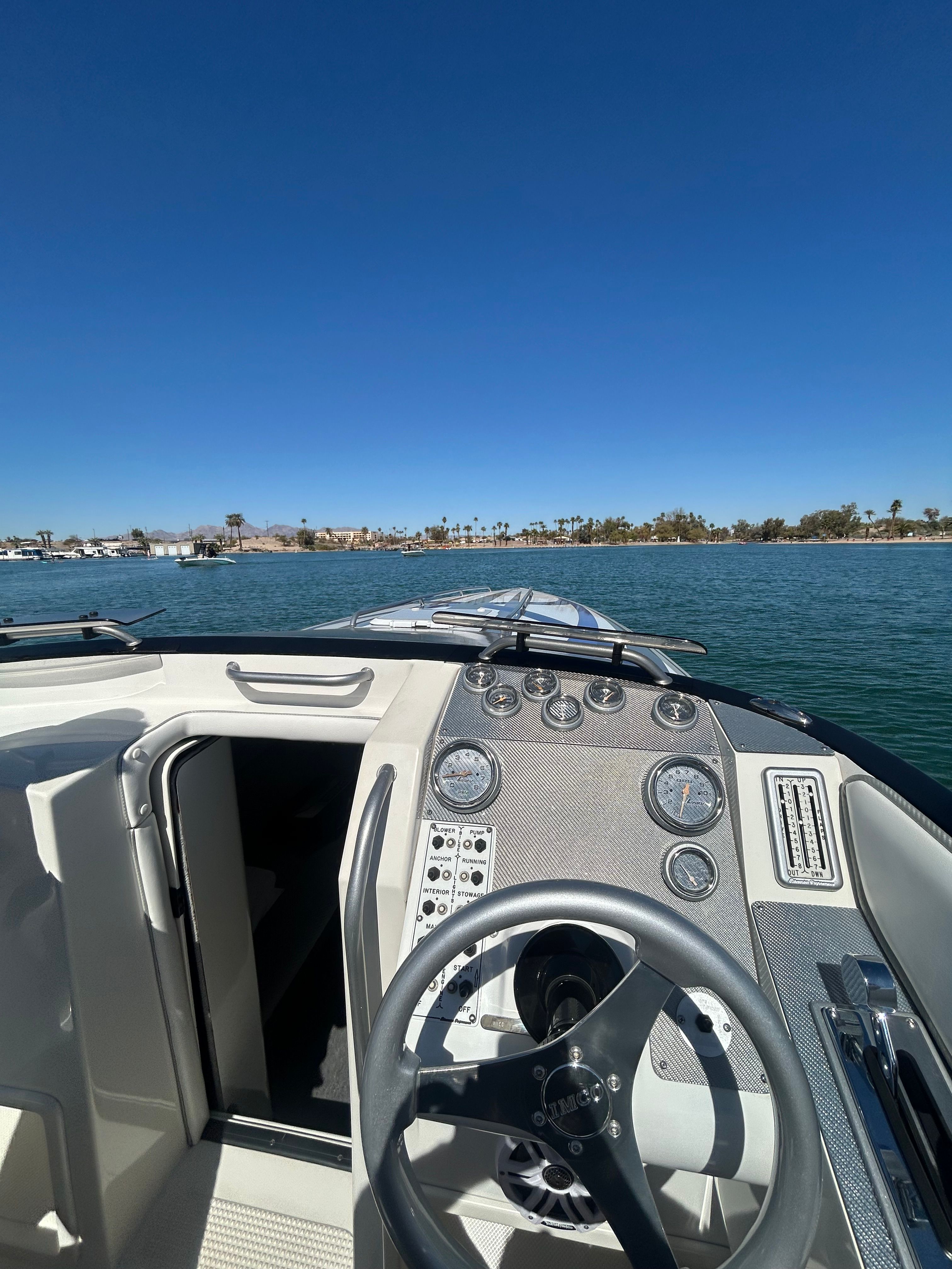 The cockpit of a 1999 Lavey Craft 2950 NuEra with a view of the water.