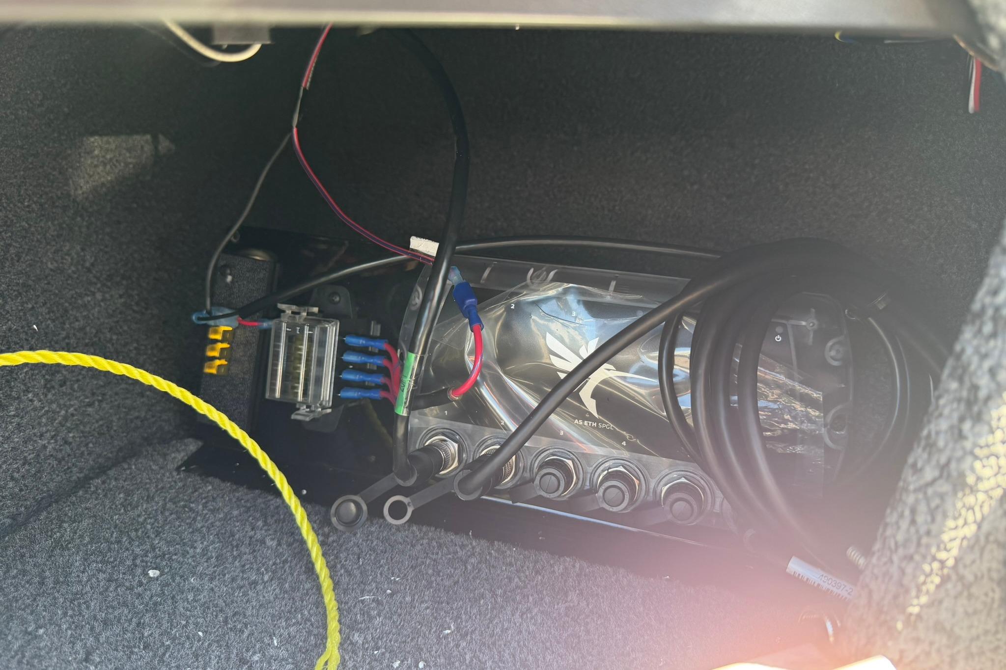 Electrical wiring and components inside a 2027 Lund 1775 Crossover XS boat compartment.