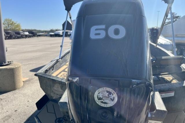 2026 Tracker Grizzly 1756 T Marsh boat with 60 HP engine in parking lot.