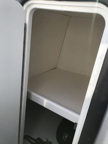 Storage compartment in 2020 Rinker 29QX BR boat.