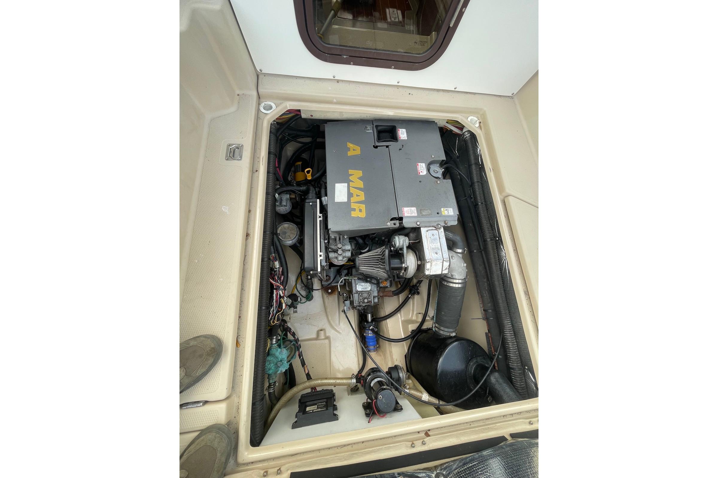 Engine compartment of 2012 Ranger Tugs R-27 boat, showcasing mechanical components.