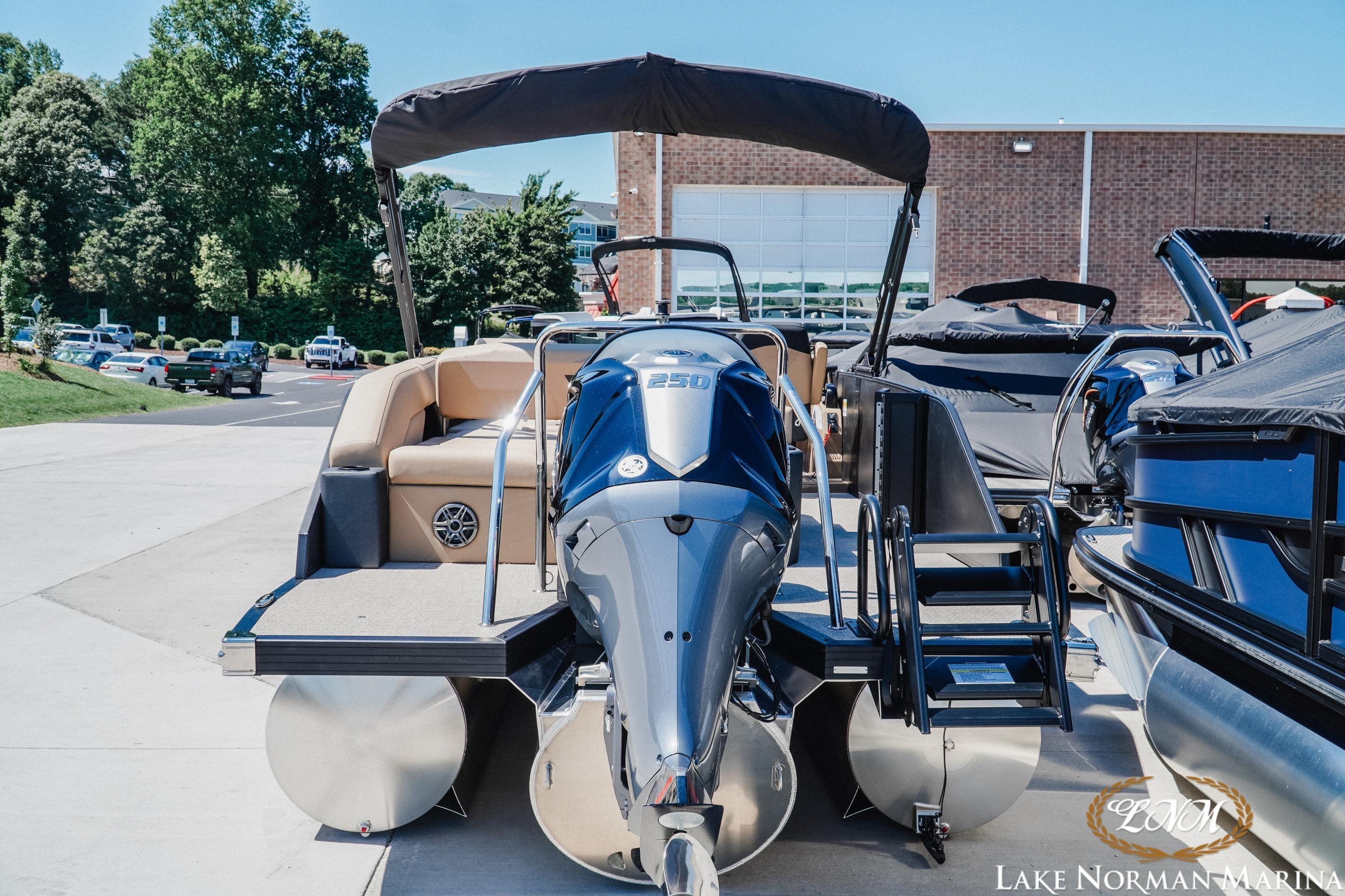 Evotti 523CS 2026 pontoon boat at Lake Norman Marina, featuring a powerful outboard motor.