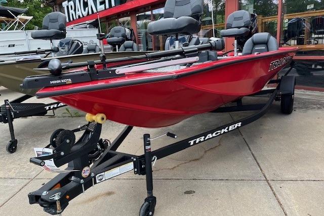 2026 Tracker Pro Team 175 boat in red, displayed on a trailer outside a dealership.