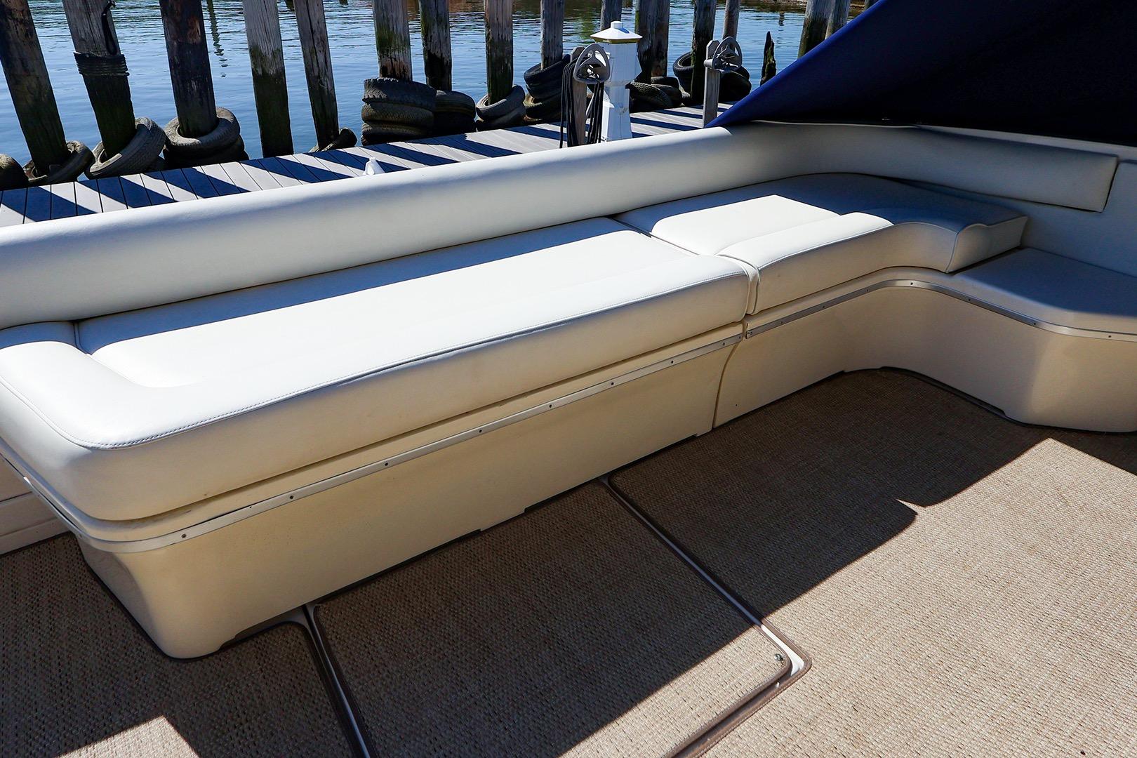 1998 Sea Ray 500 Sundancer boat with white cushioned seating on deck.