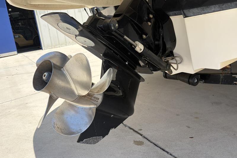 Propeller and stern drive of 2007 Sea Ray 240 Sundeck boat on concrete surface.