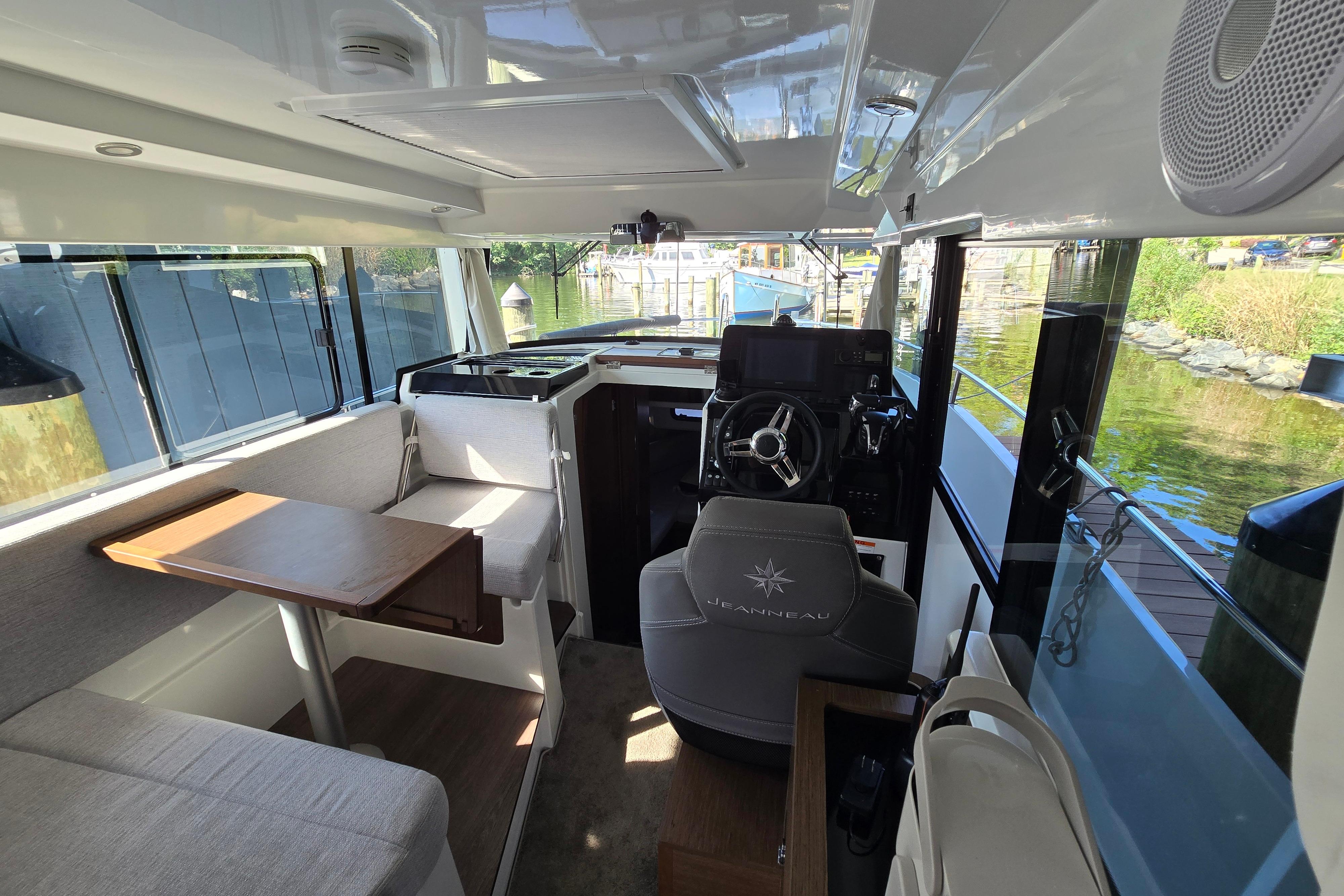Interior of the Jeanneau NC Sport 895 with helm and seating area.