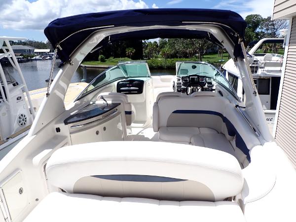 2011 Chaparral 287 SSX boat interior with white seating and blue accents, docked by a serene lake.
