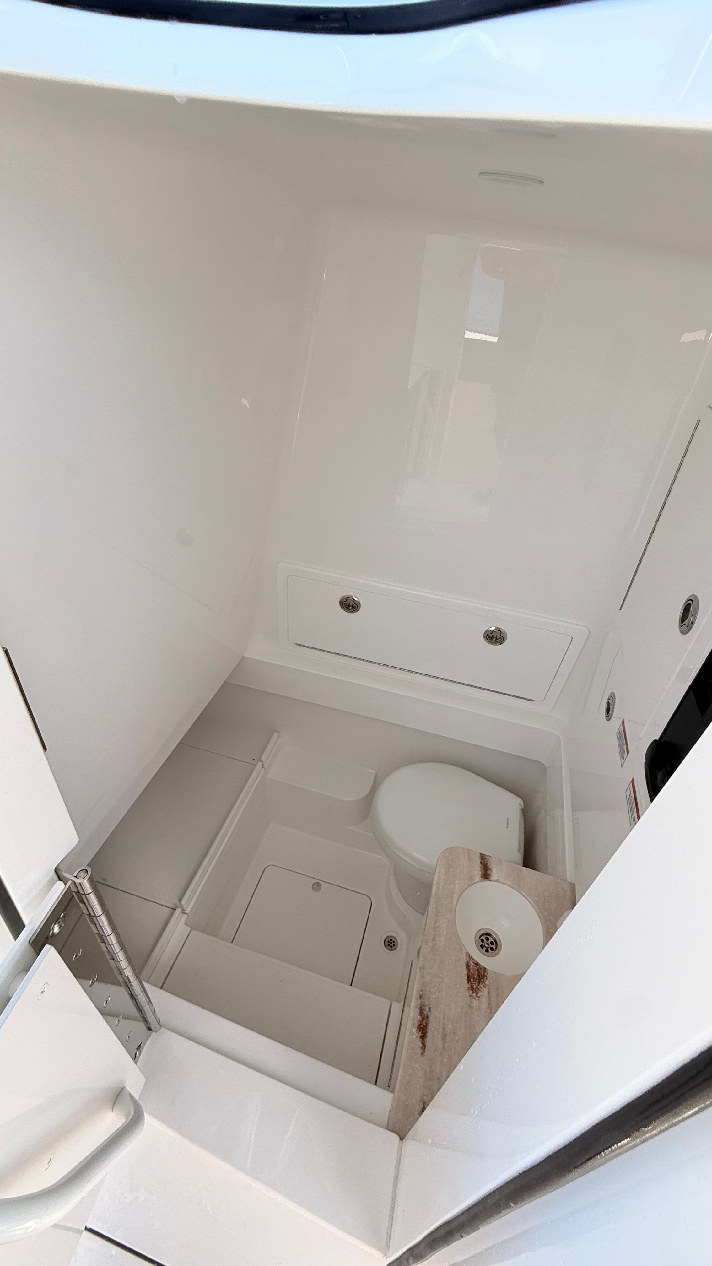 Interior of 2026 Valhalla Boatworks V33 with toilet and storage.