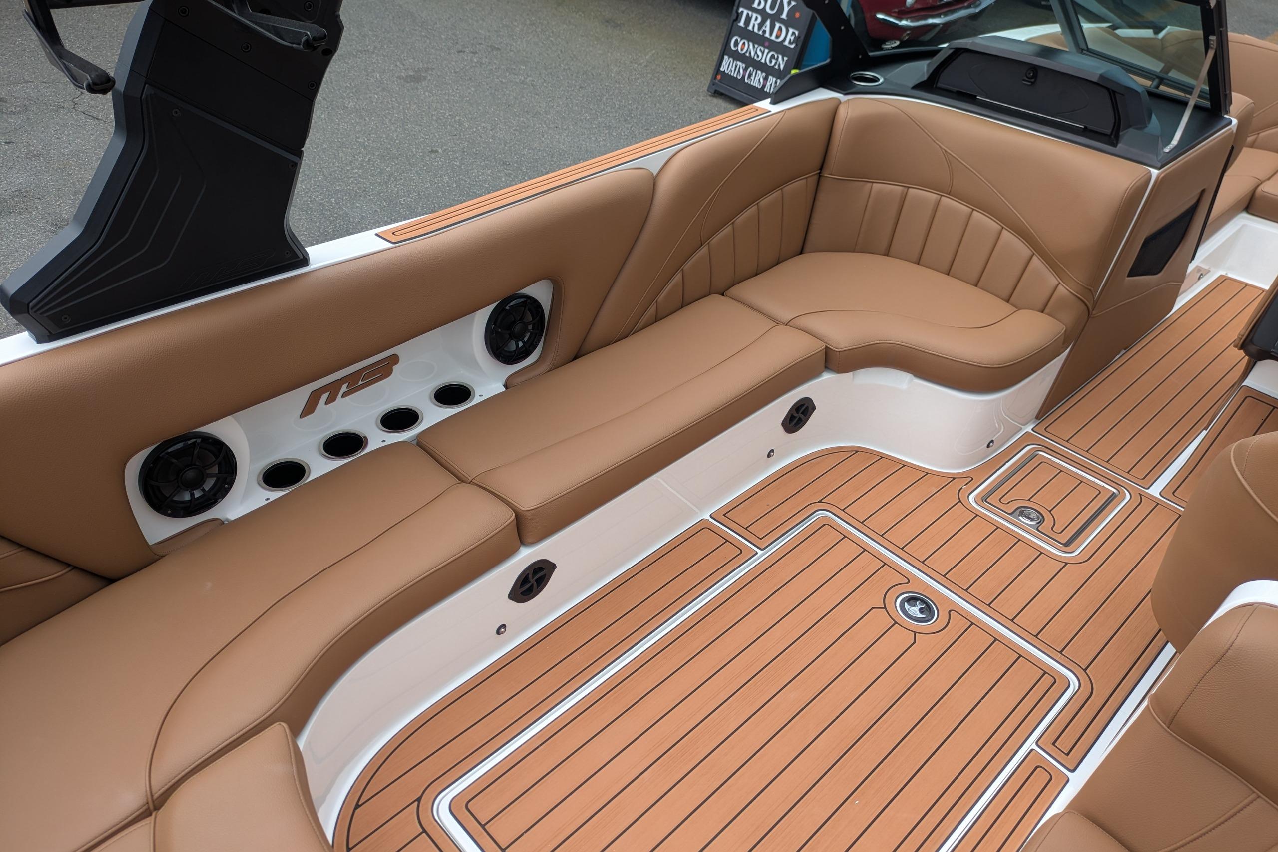 2026 MB B52-23 Classic LIMITED boat interior with tan leather seating and teak-style flooring.