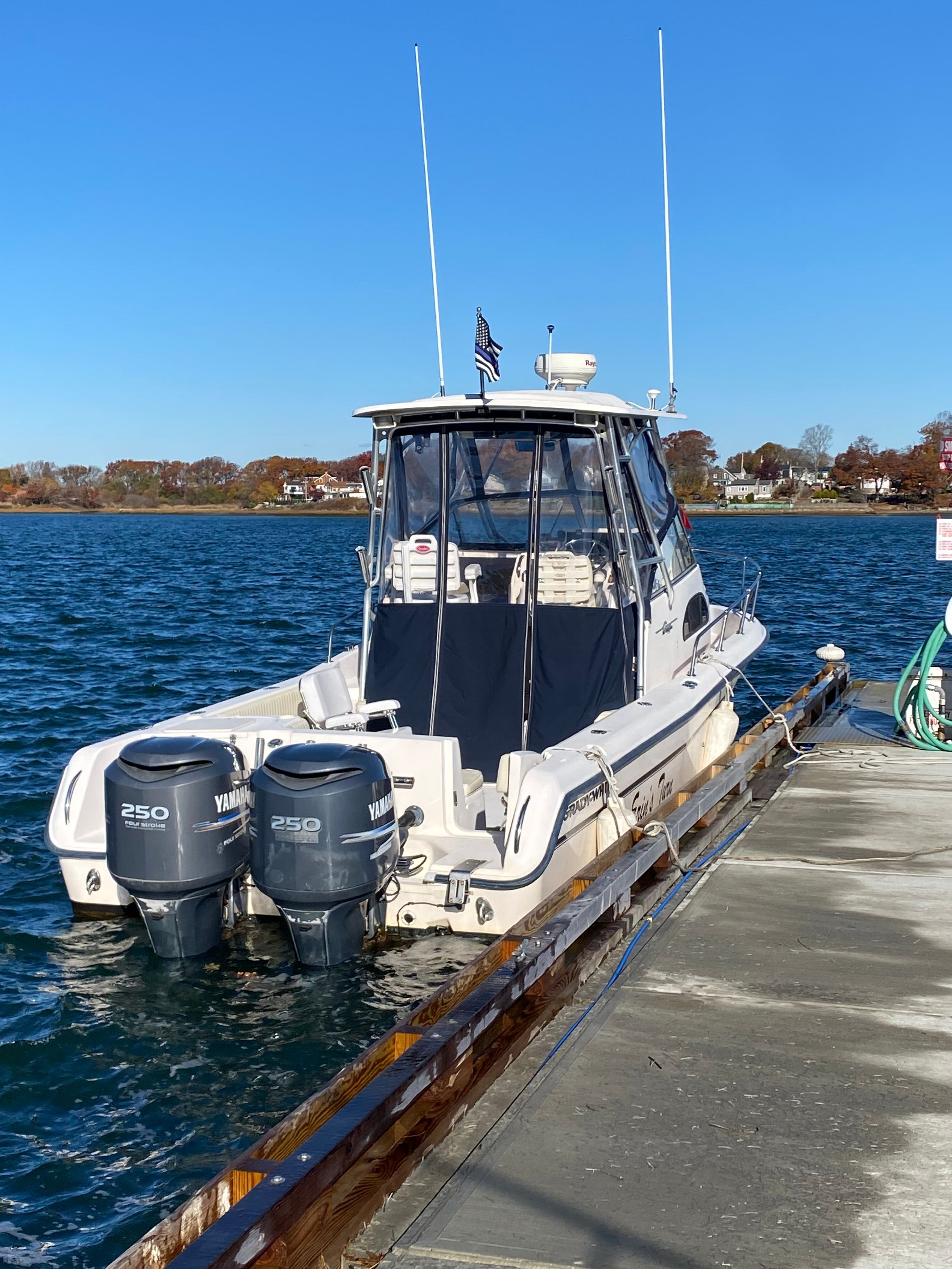 A 2003 Grady-White Sailfish 282 docked. Two Yamaha engines are visible.