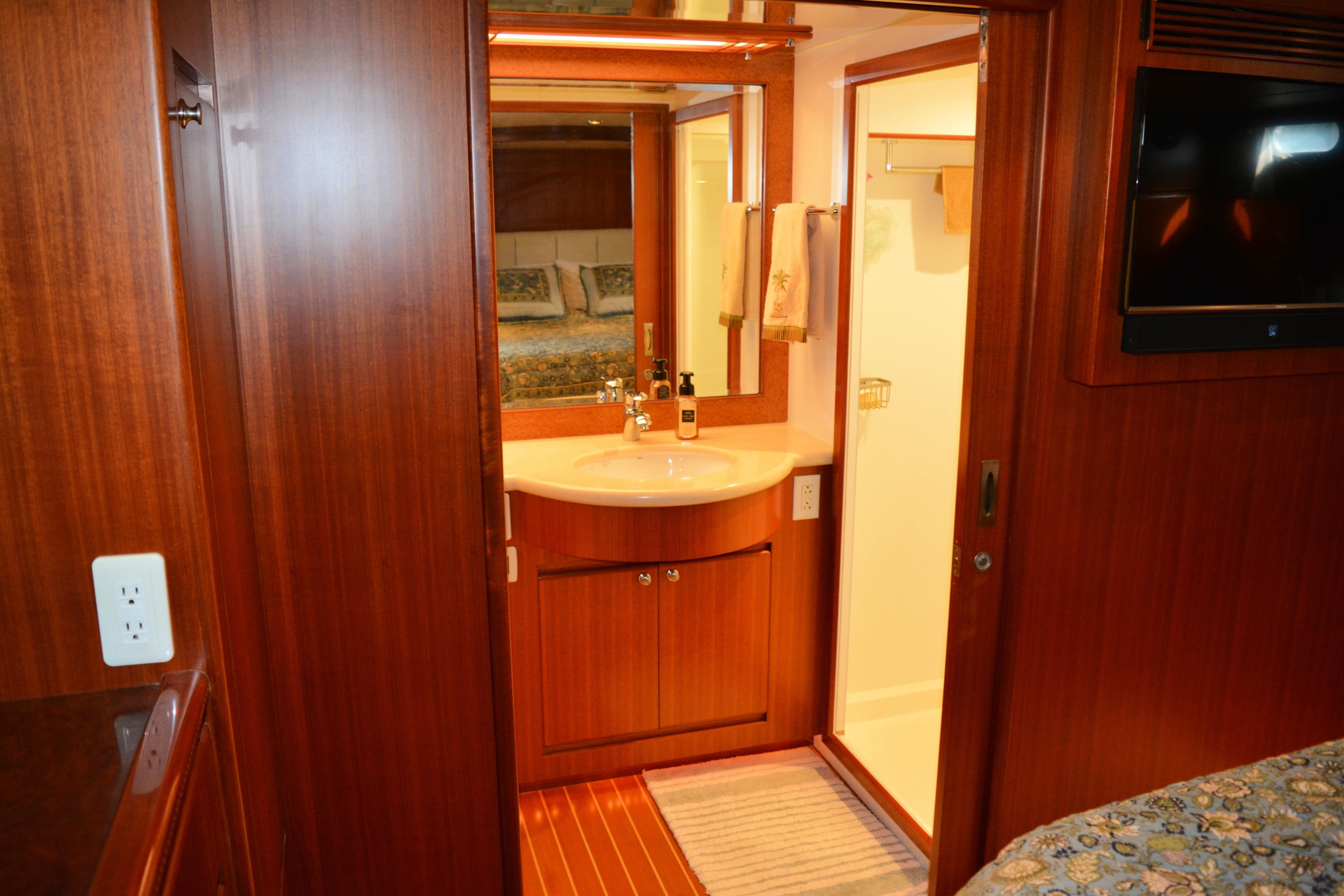 Luxurious bathroom interior of 2008 Novatec Islander 60 yacht with wood finish and modern amenities.