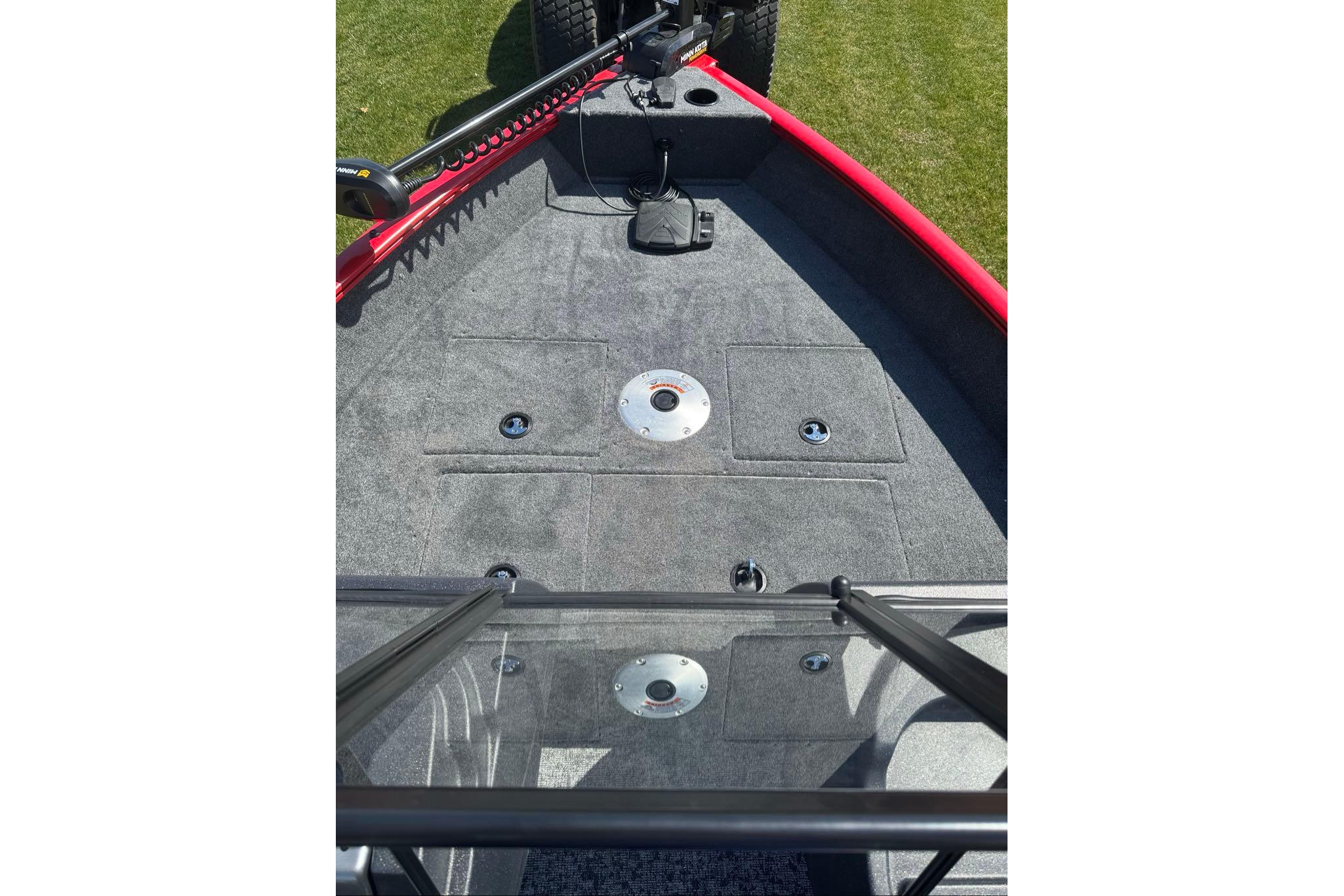 2026 Tracker Pro Guide V-16 WT boat deck with red trim and fishing rod holders.