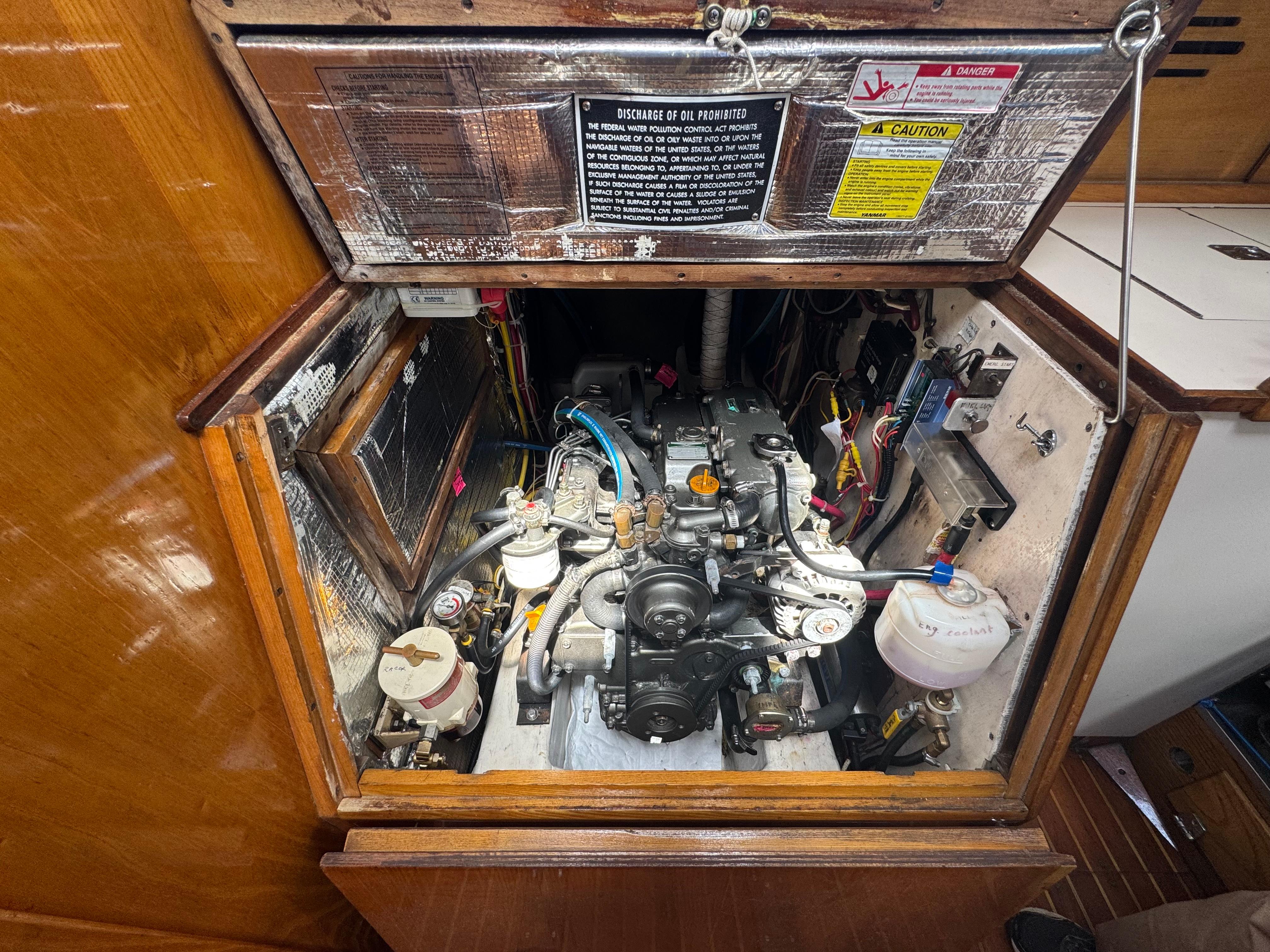 Engine compartment of a 1983 Hinckley Sou'wester 42 sailboat, showcasing detailed mechanical components.