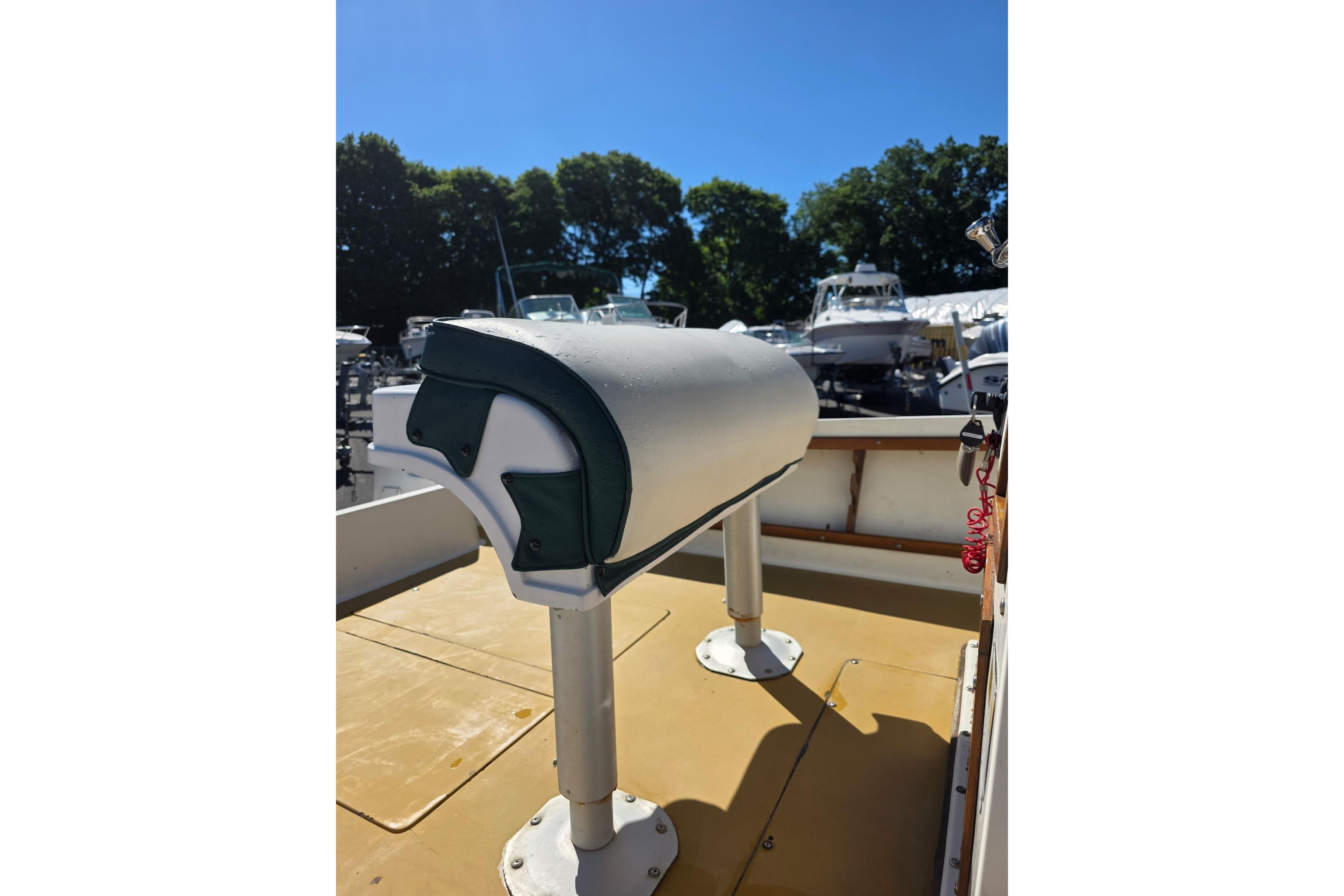 1982 Mako 20 Center Console boat interior with cushioned seating and sunny outdoor setting.
