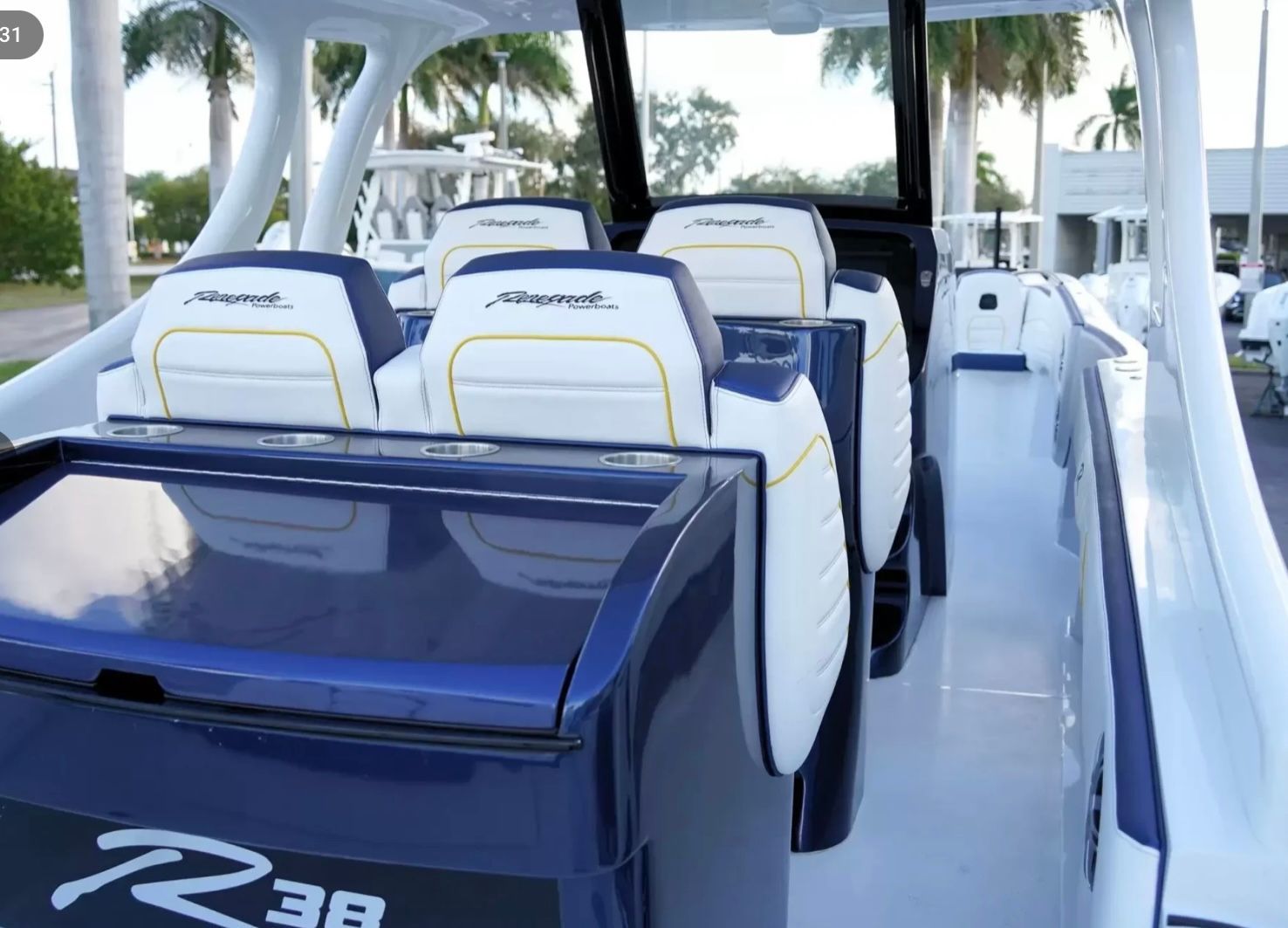 The image shows the cockpit of a Renegade boat with stylish seating and a modern design.