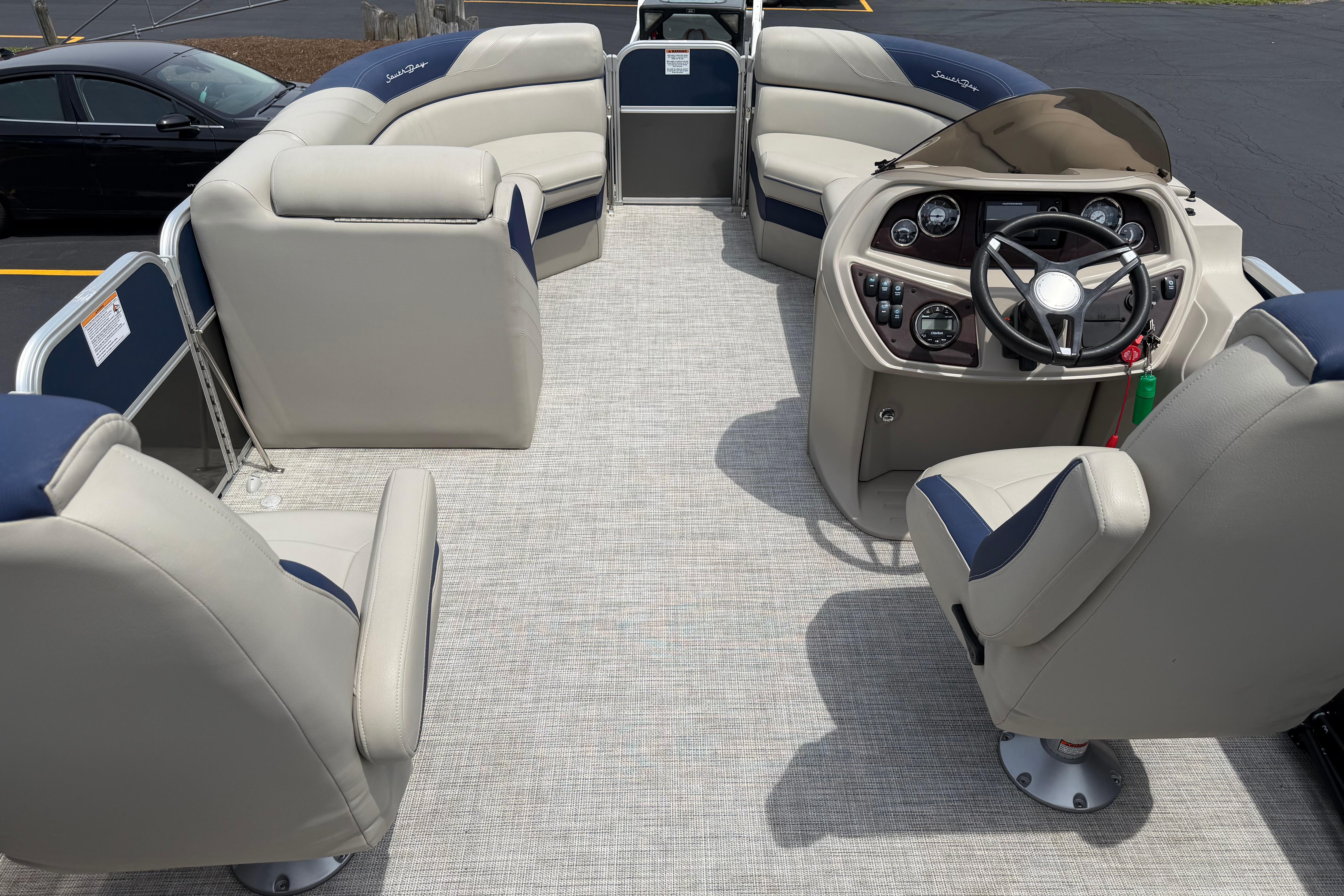 Interior of a 2021 South Bay 224RS LE pontoon boat with beige and blue seating.
