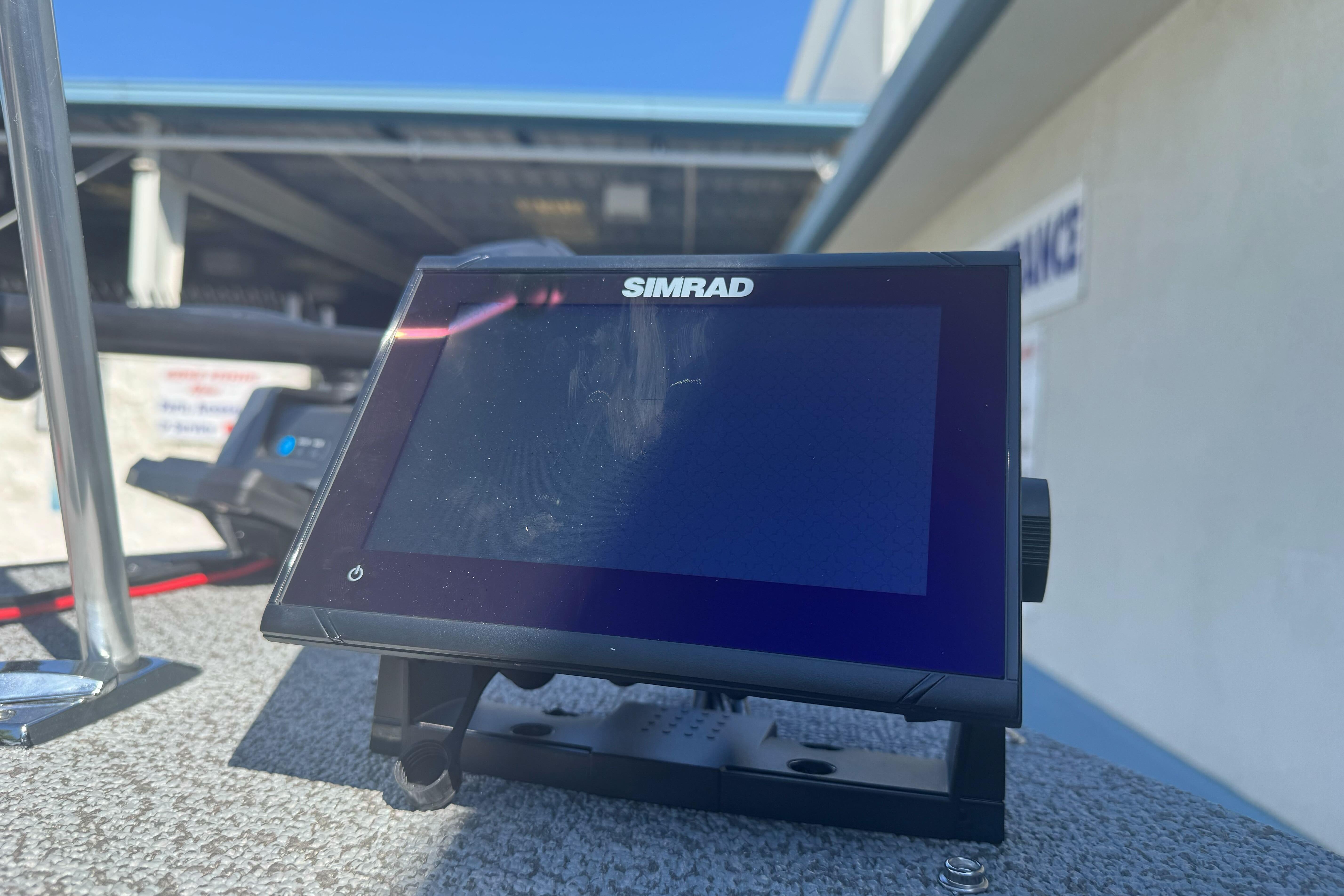Simrad display on 2026 Lund 1650 Rebel XL SS boat, outdoor setting.