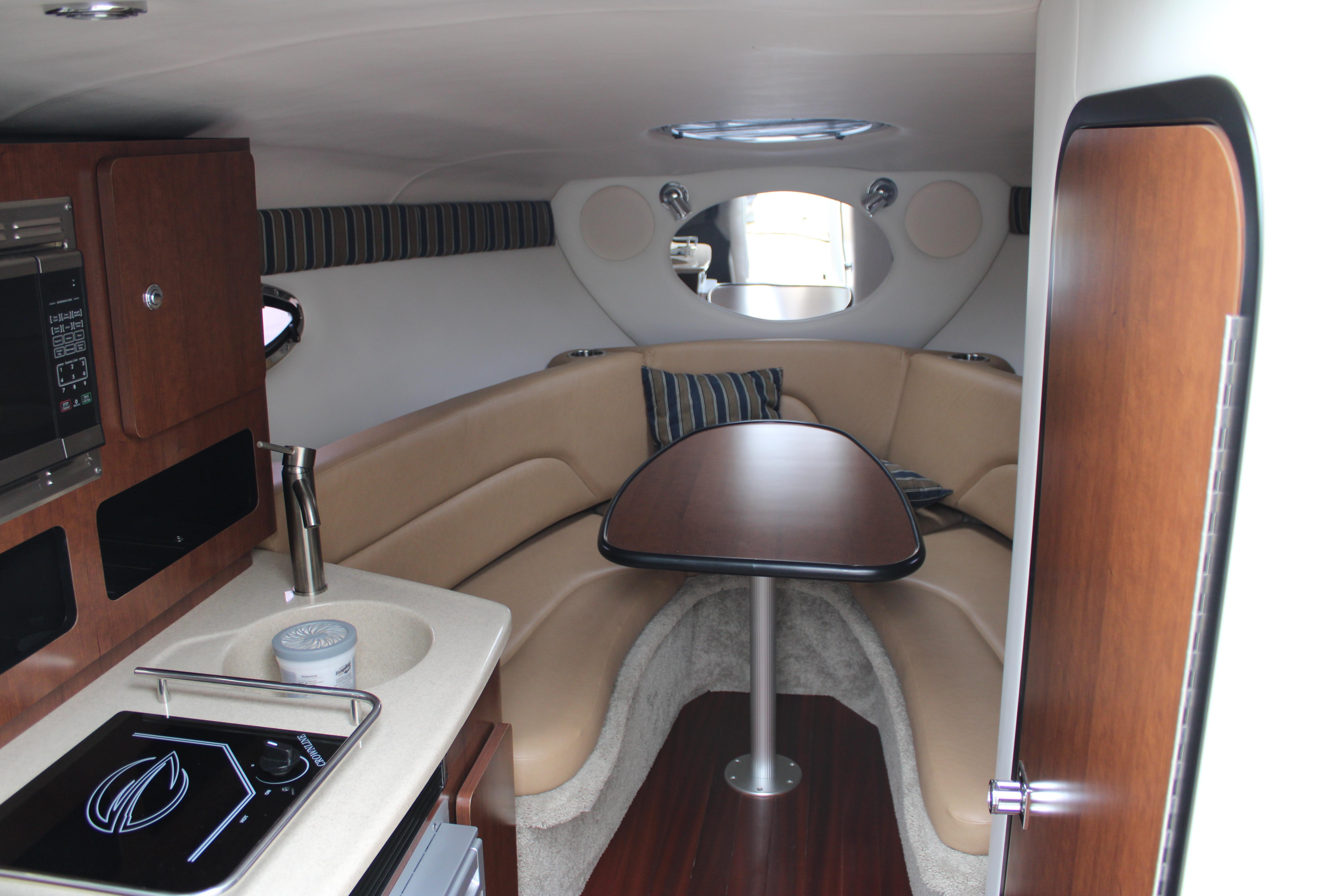 Interior of 2020 Crownline 264 CR boat with cozy seating and kitchenette.
