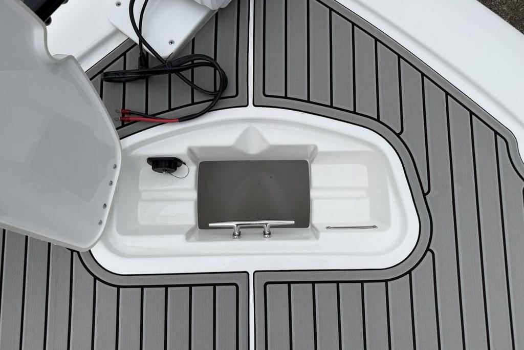 2026 Tidewater 2500 Carolina Bay boat deck with storage compartment and sleek design.
