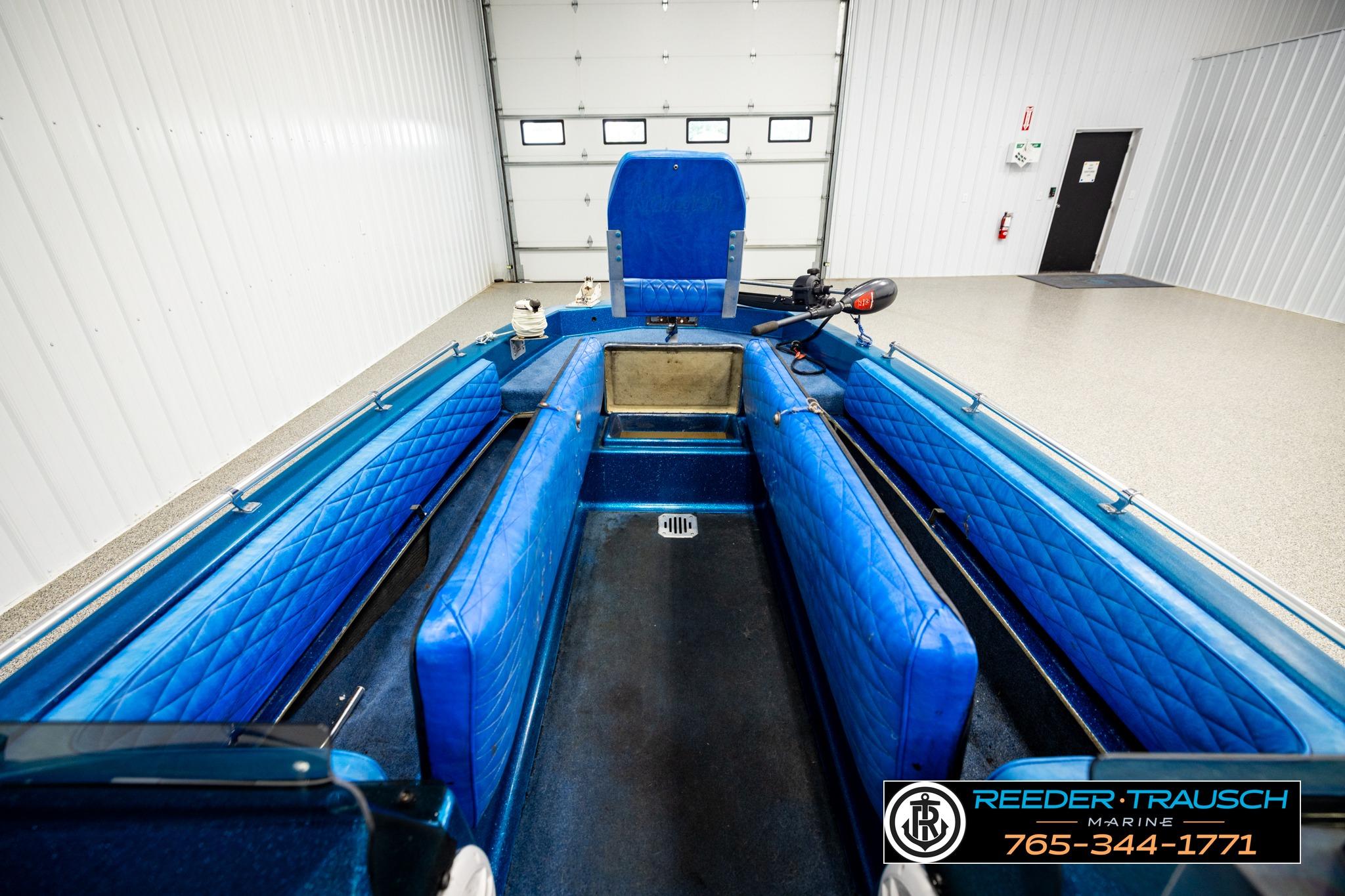 1980 Ranger 175 VS boat interior with blue seating, displayed in a showroom.