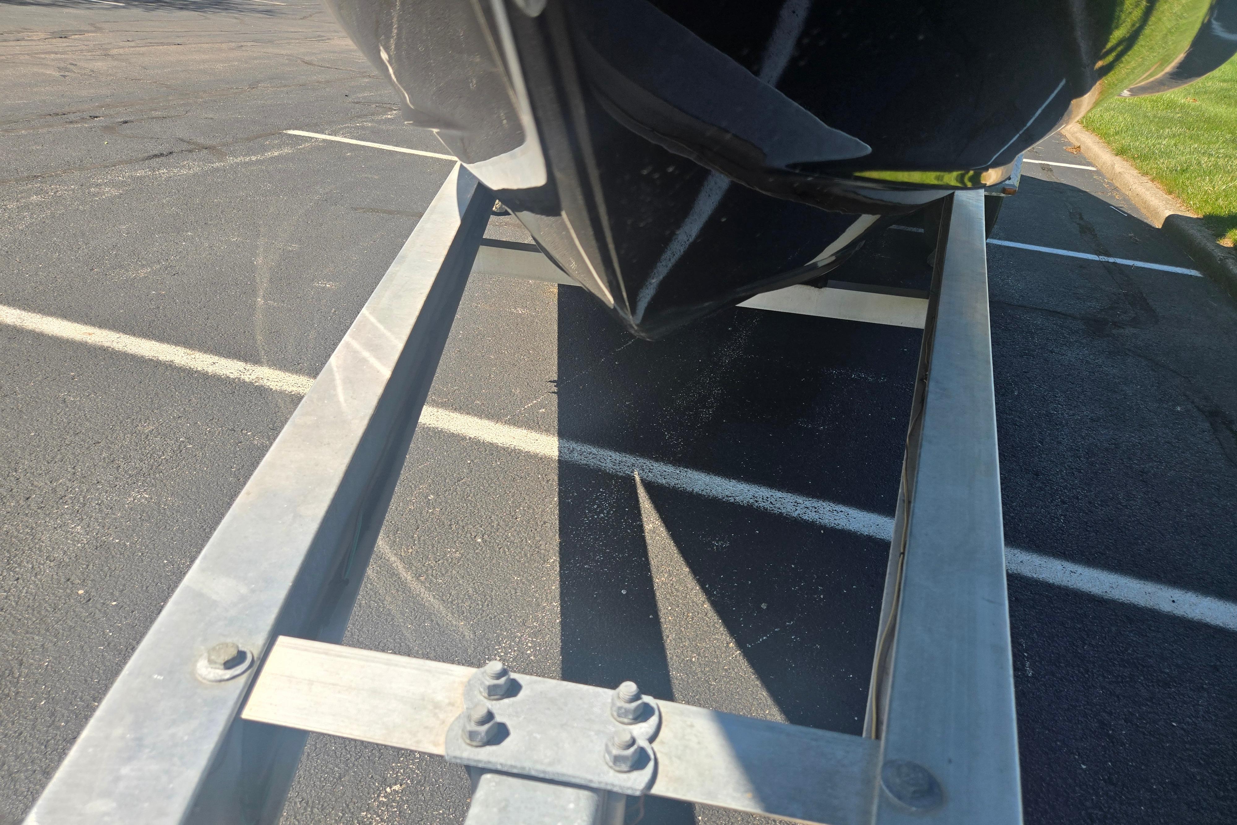 2018 Chaparral 267 SSX boat on trailer, parked on asphalt.