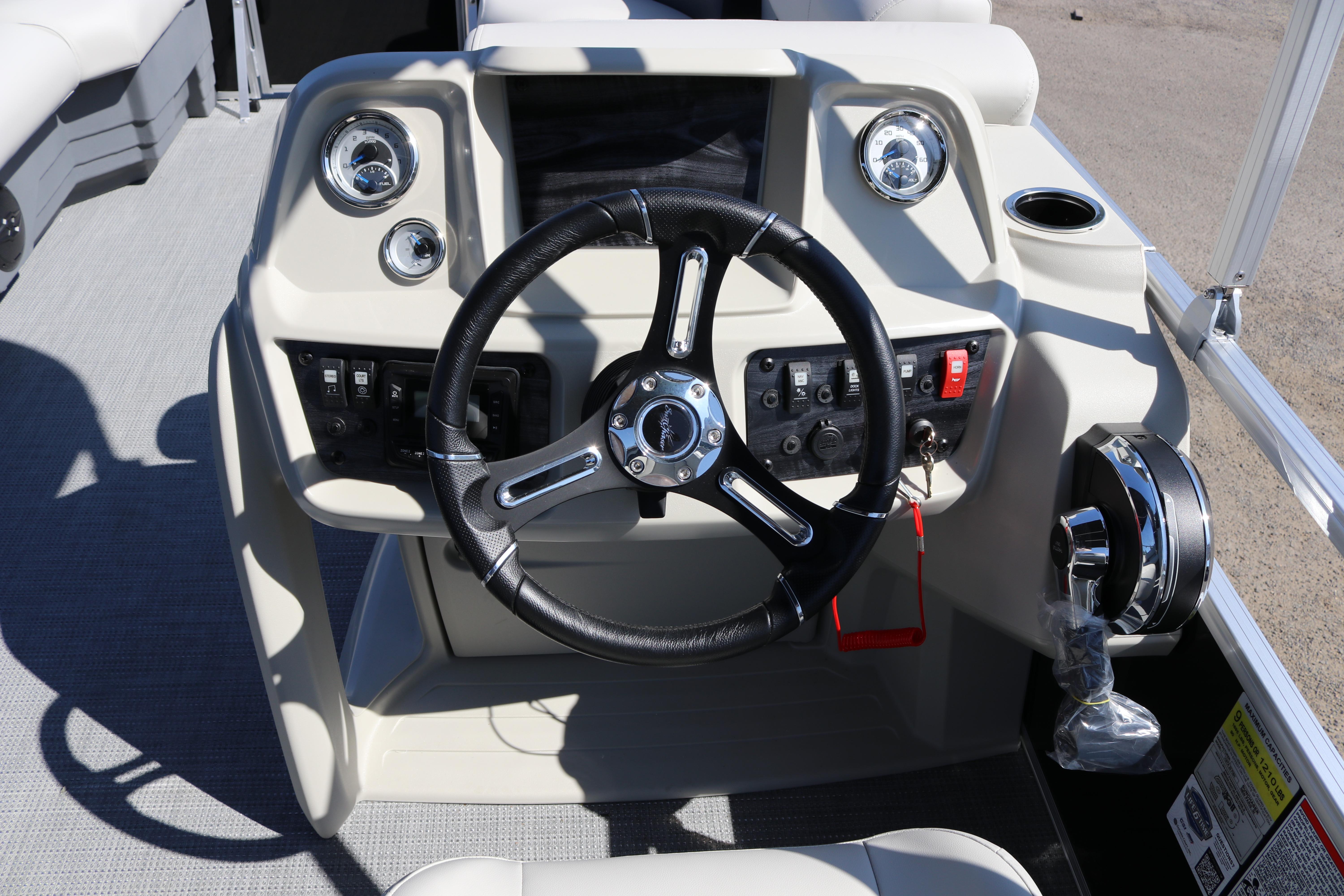 2025 SunChaser Vista 20 Fish boat dashboard with steering wheel and control panel.