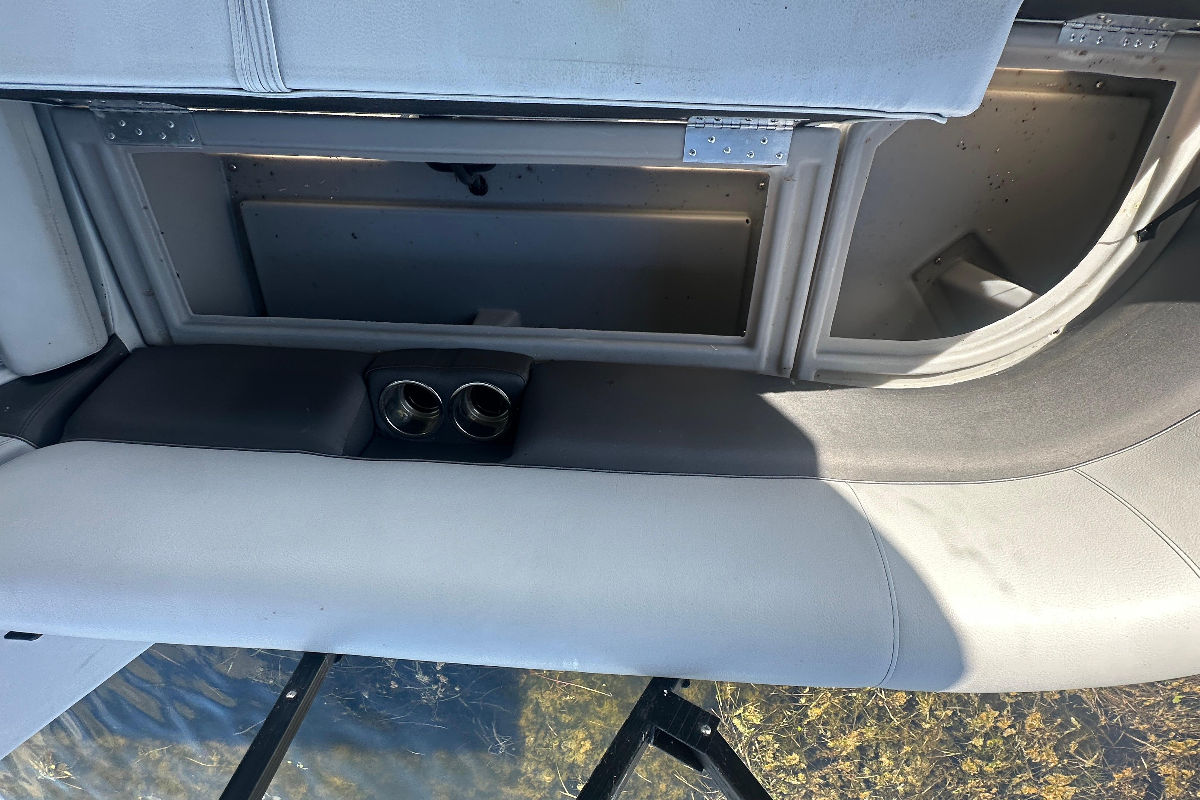 2023 Bentley Pontoons Legacy 243 Swingback interior storage compartment with cup holders.