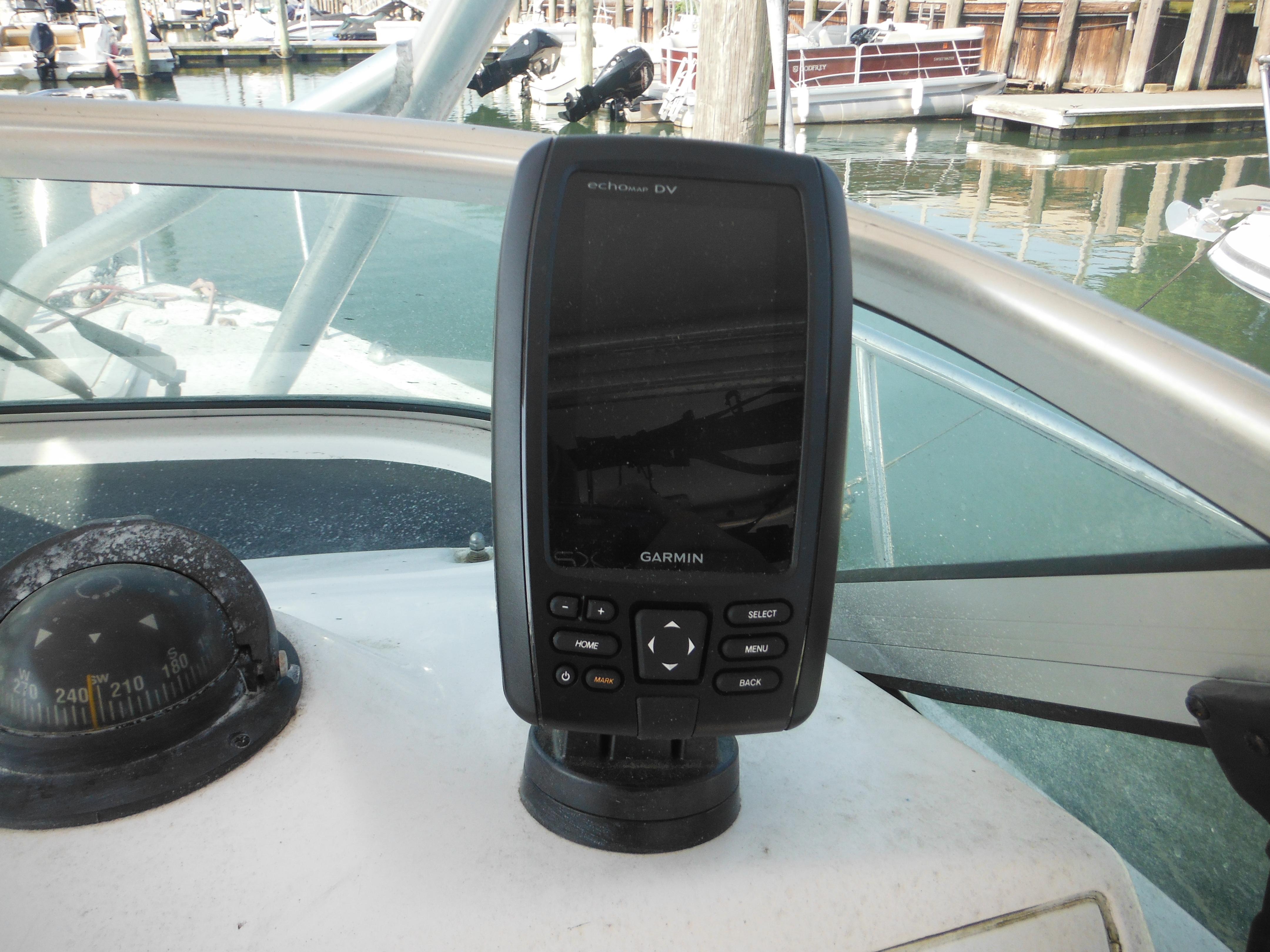 Garmin device on 2002 Pro-Line 23 Walk boat dashboard at marina.